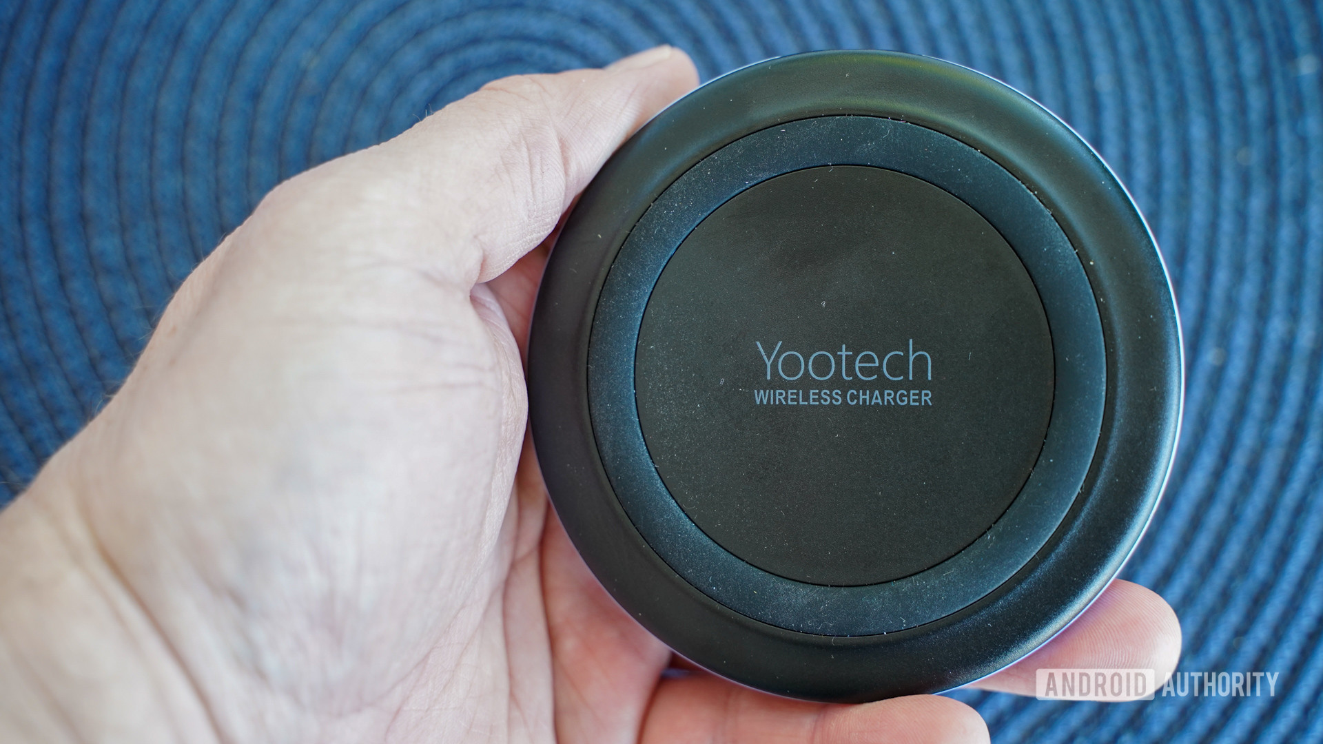 Yootech F500 Wireless Charger in the hand for size