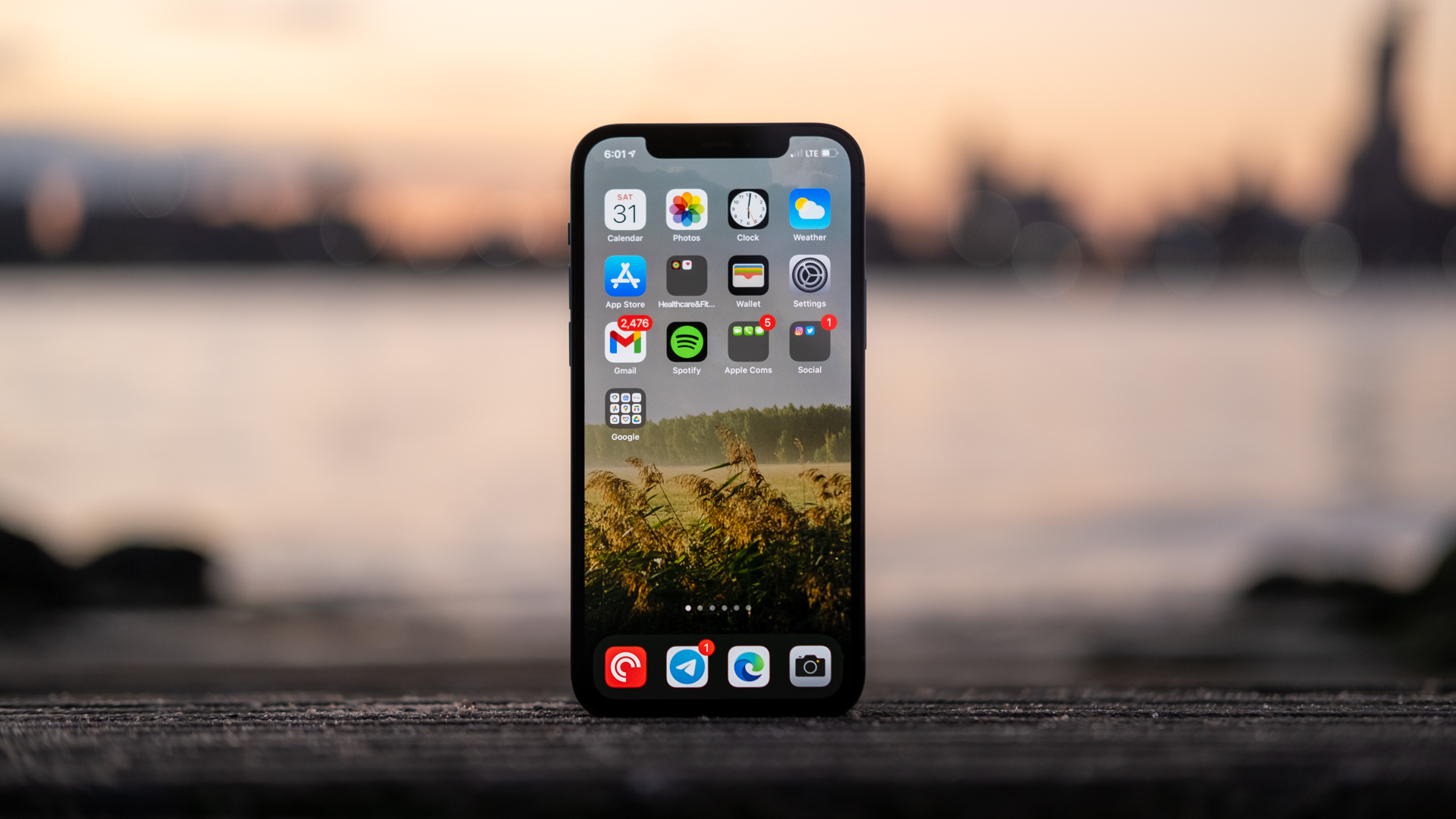 iPhone 12 Pro display standing up agaist sunset