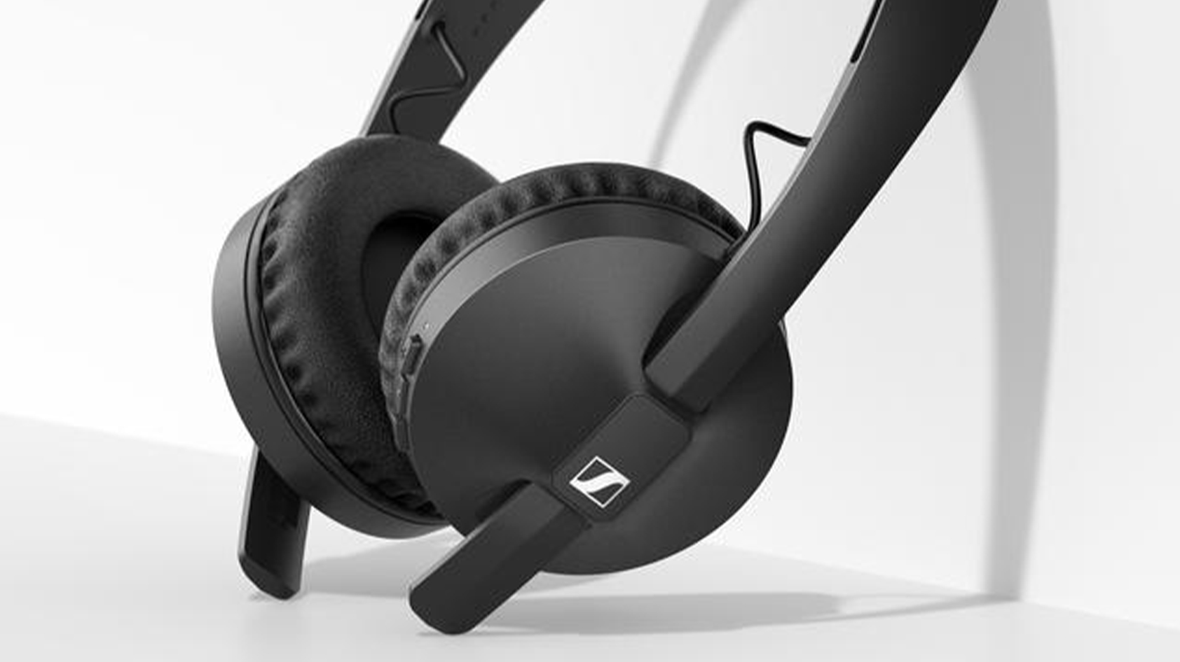 The Sennheiser HD 250BT on-ear wireless headphones in black rest against a white surface.