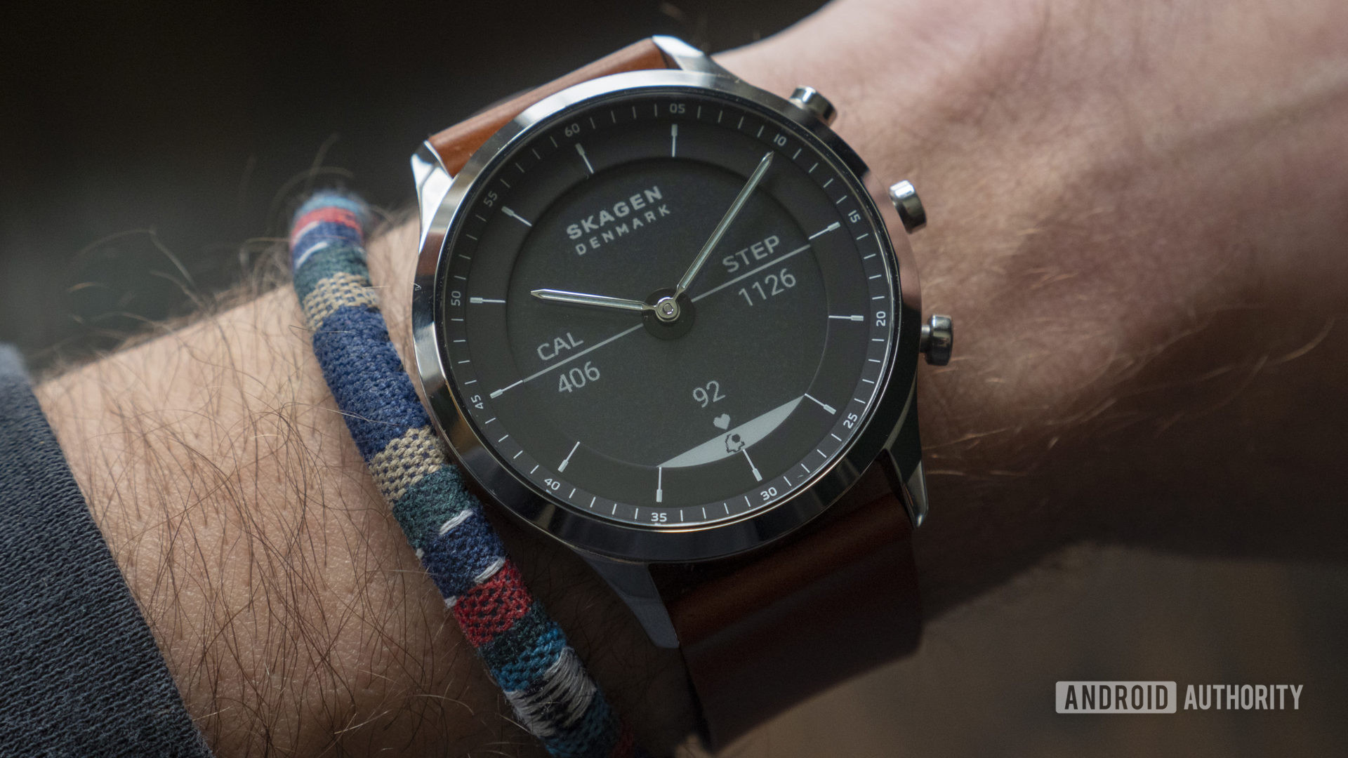 A SKAGEN Jorn Hybrid HR on a user's wrist showcases the device's e-ink display.