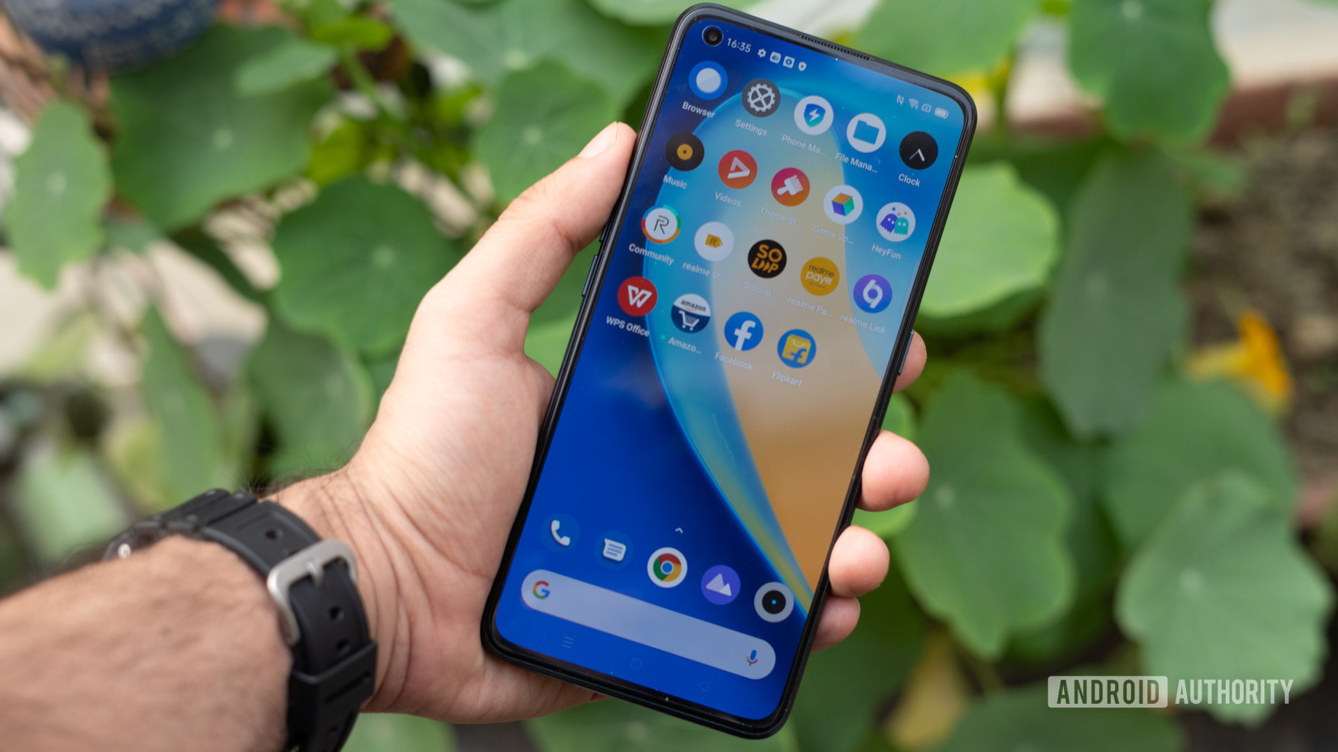 realme X7 Pro 5G phone and display on in hand
