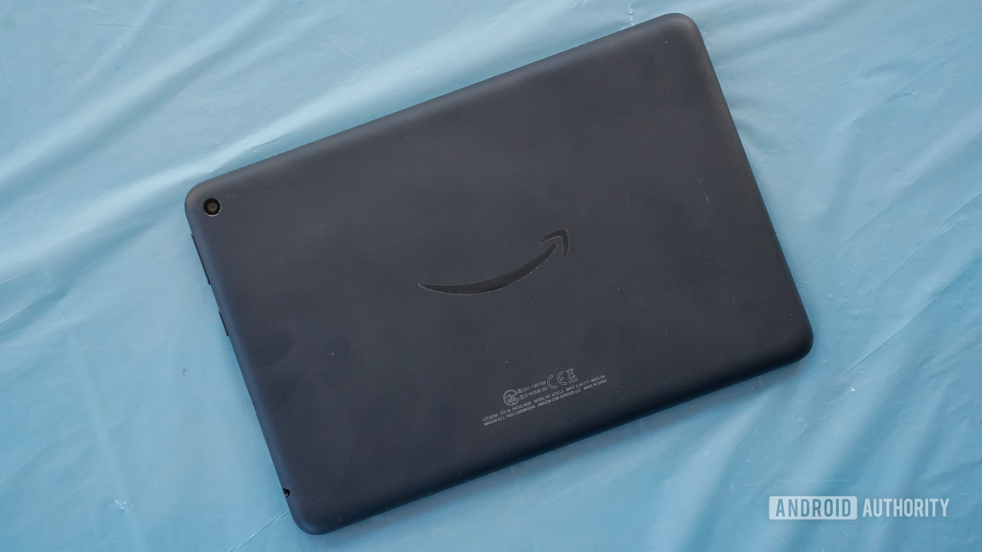 Amazon Fire 8 HD Plus rear panel on a blue background