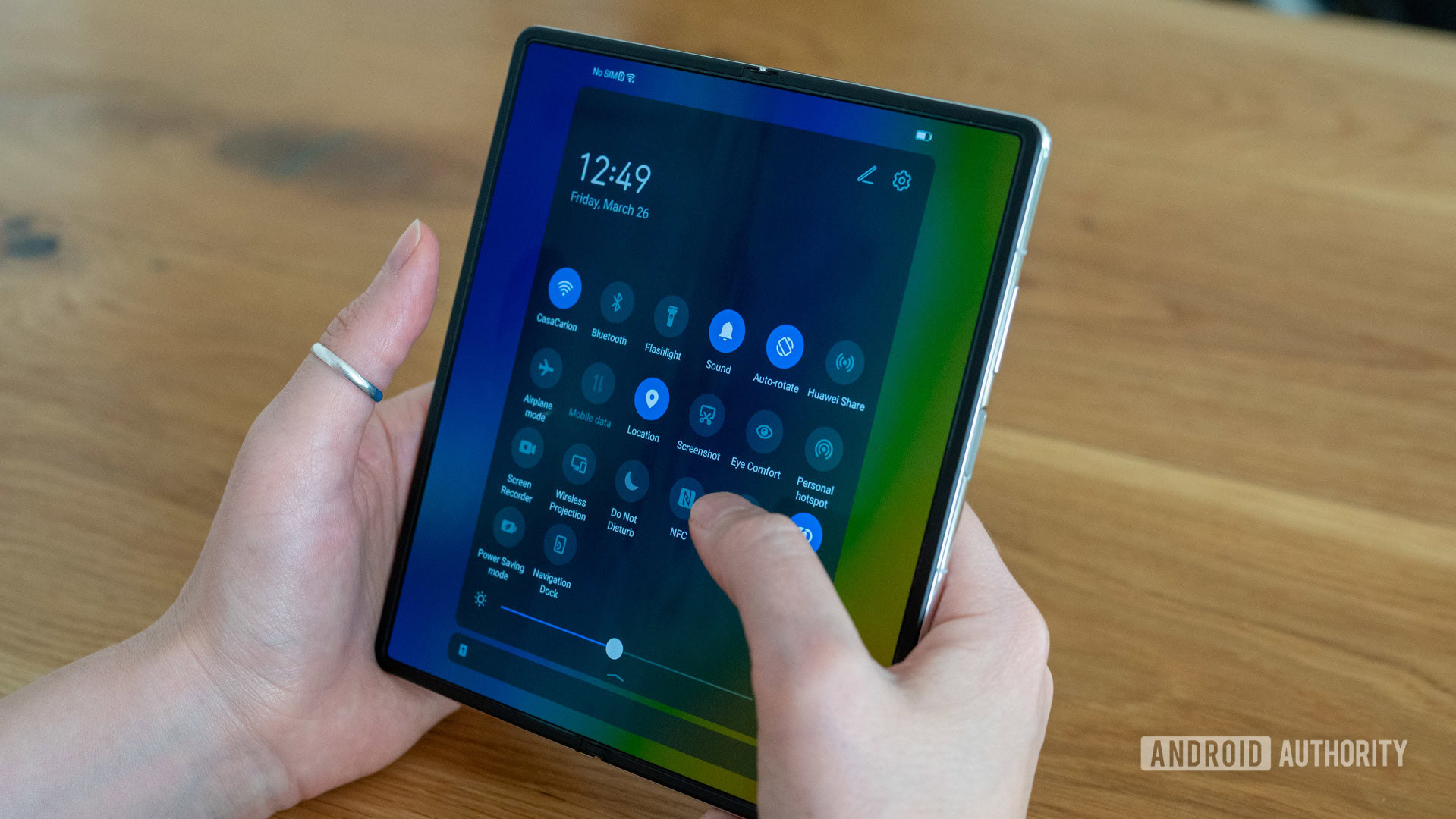 Huawei Mate X2 review quick settings on main internal screen over shoulder