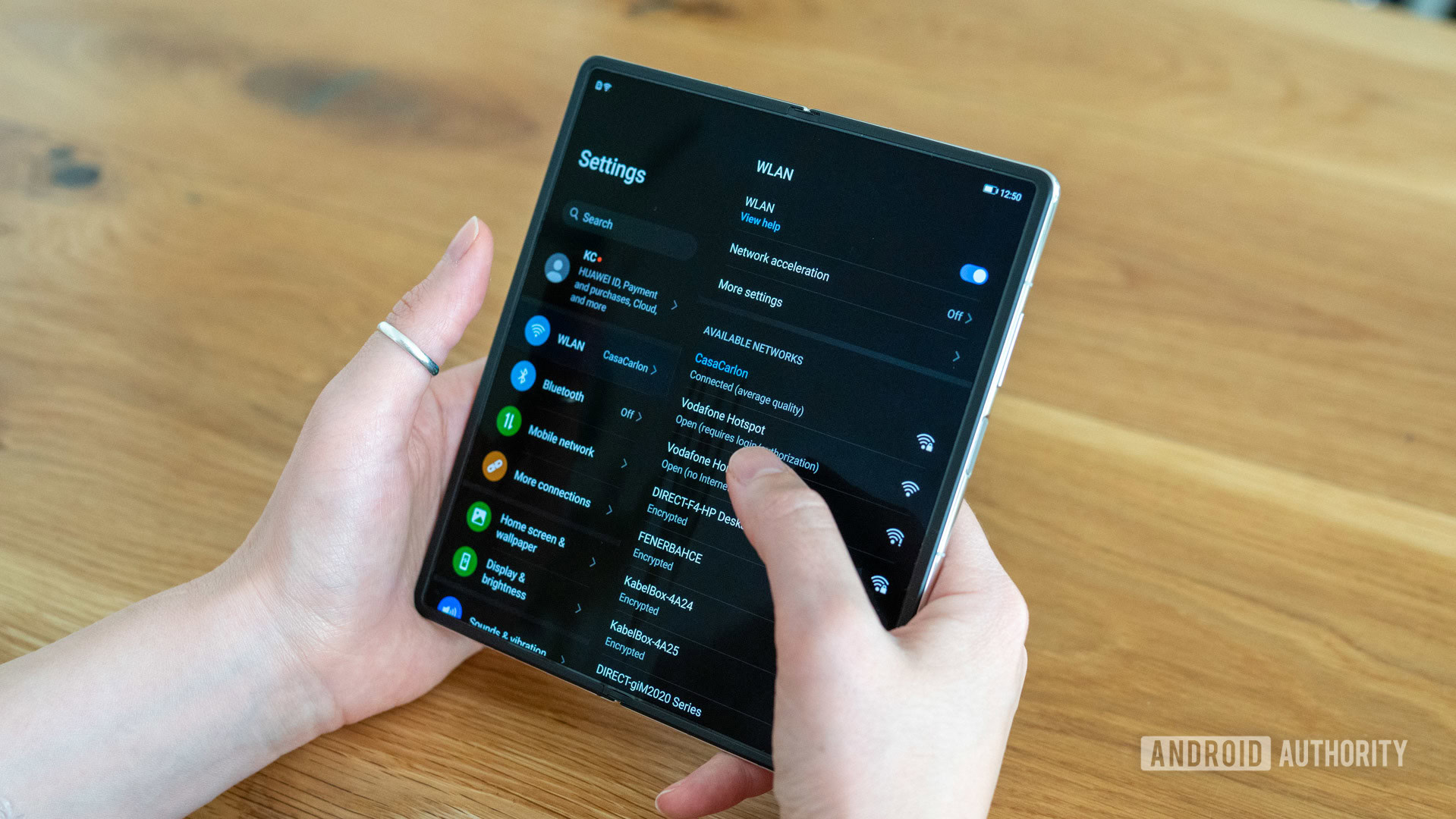 Huawei Mate X2 review settings menu on main internal screen over shoulder