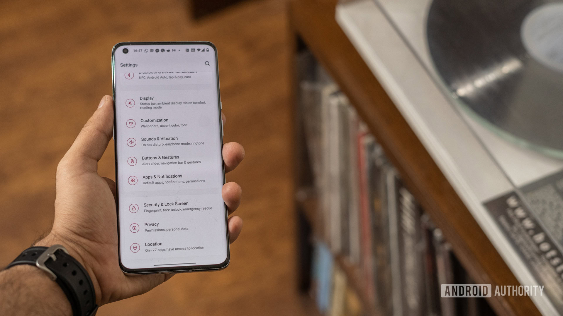 OnePlus 9 Pro in hand with display on