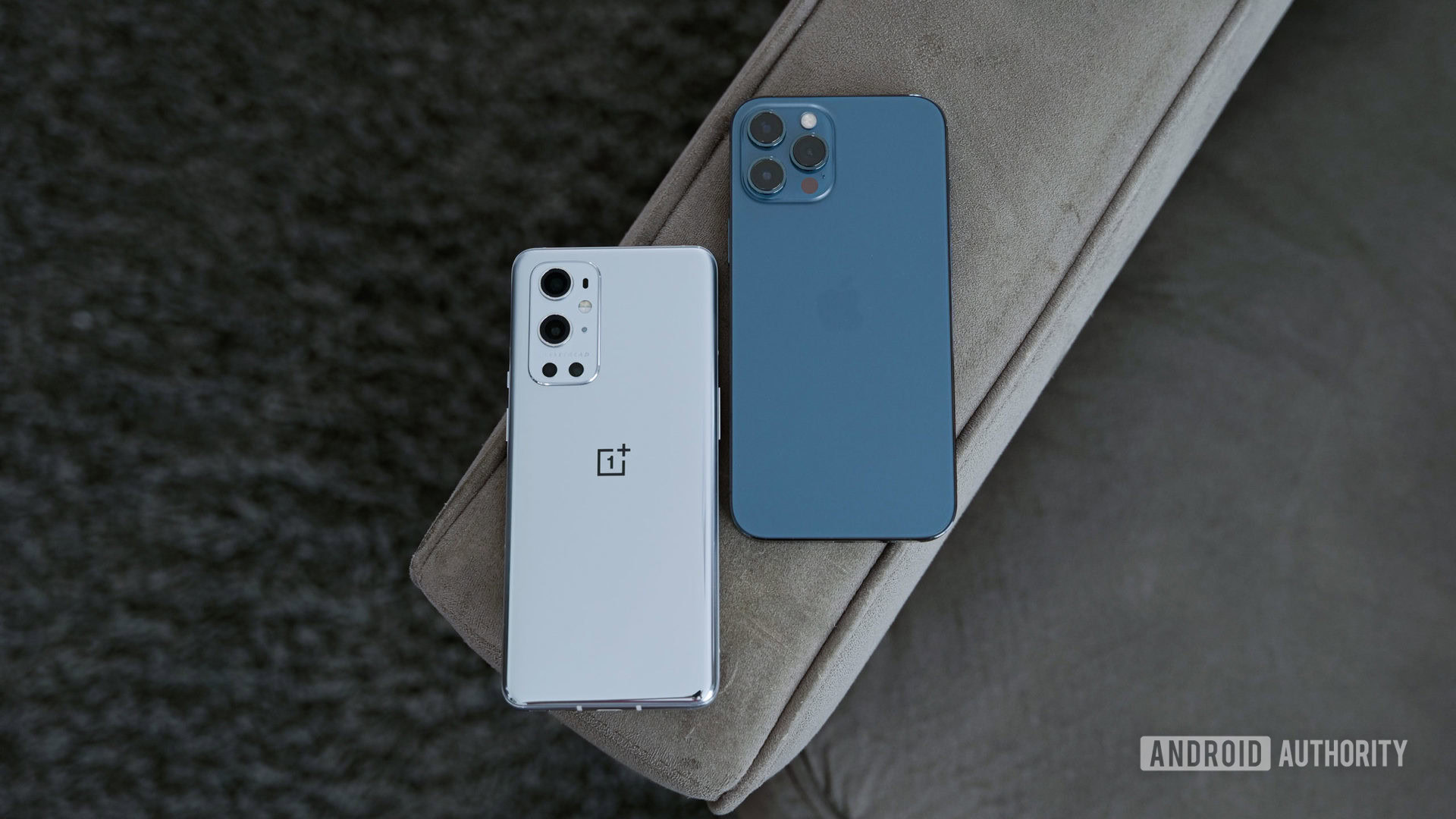 OnePlus 9 Pro vs iPhone 12 Pro Max on couch arm