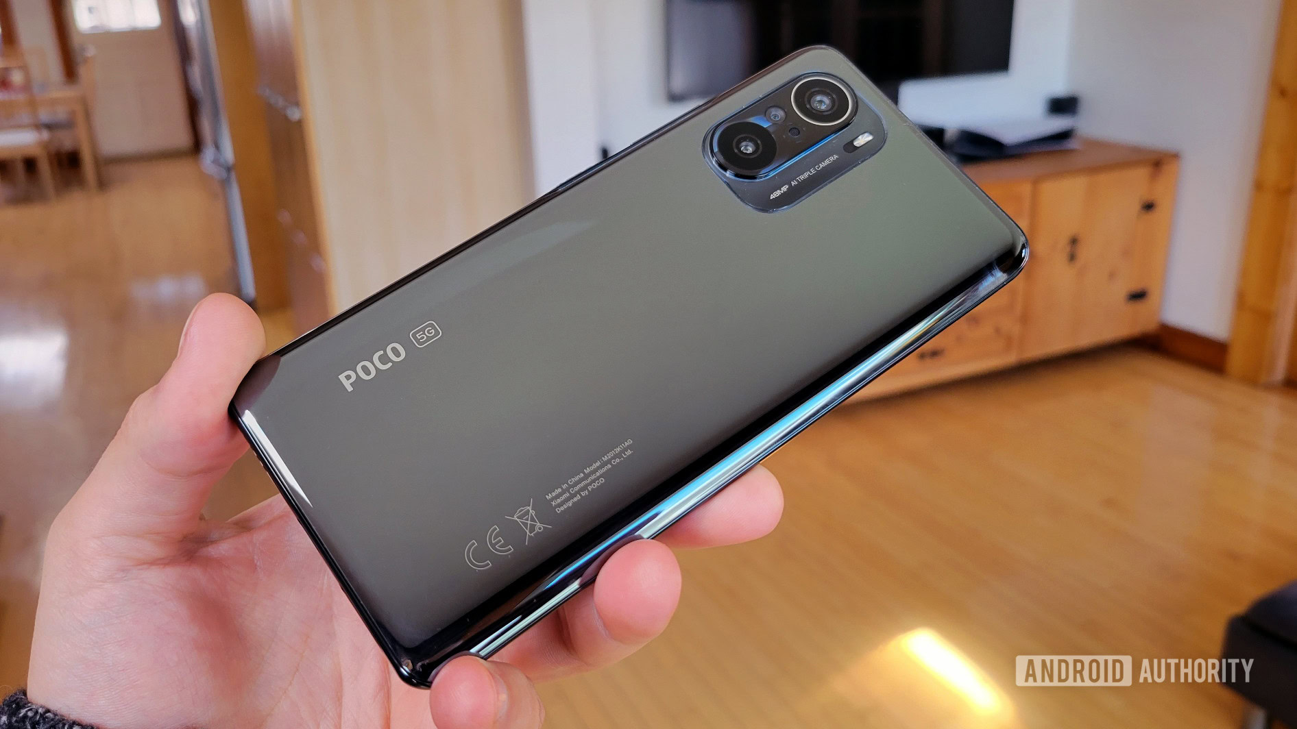 Poco F3 back of phone in hand.