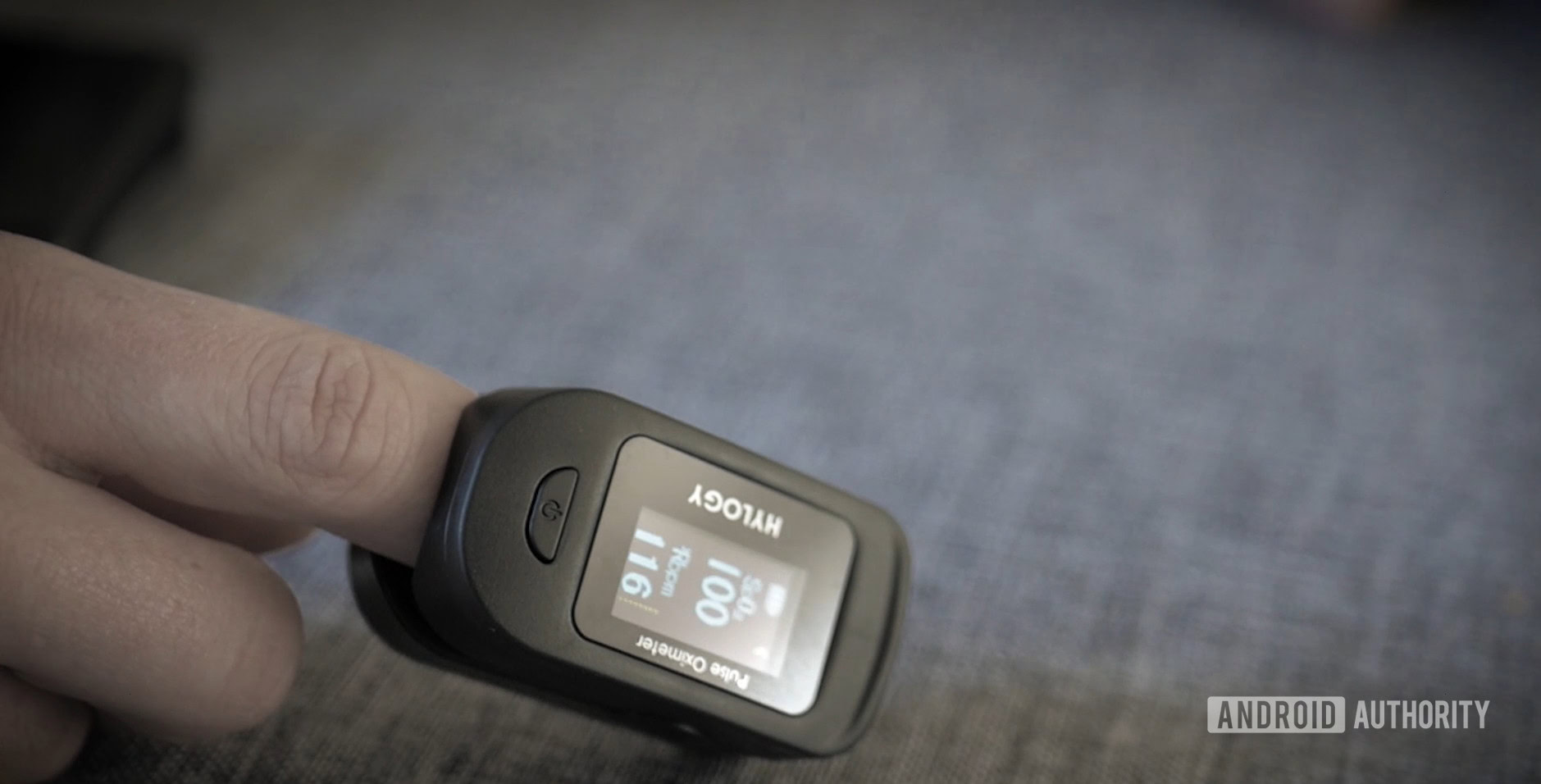 A user tests their SpO2 with a fingertip pulse oximeter.
