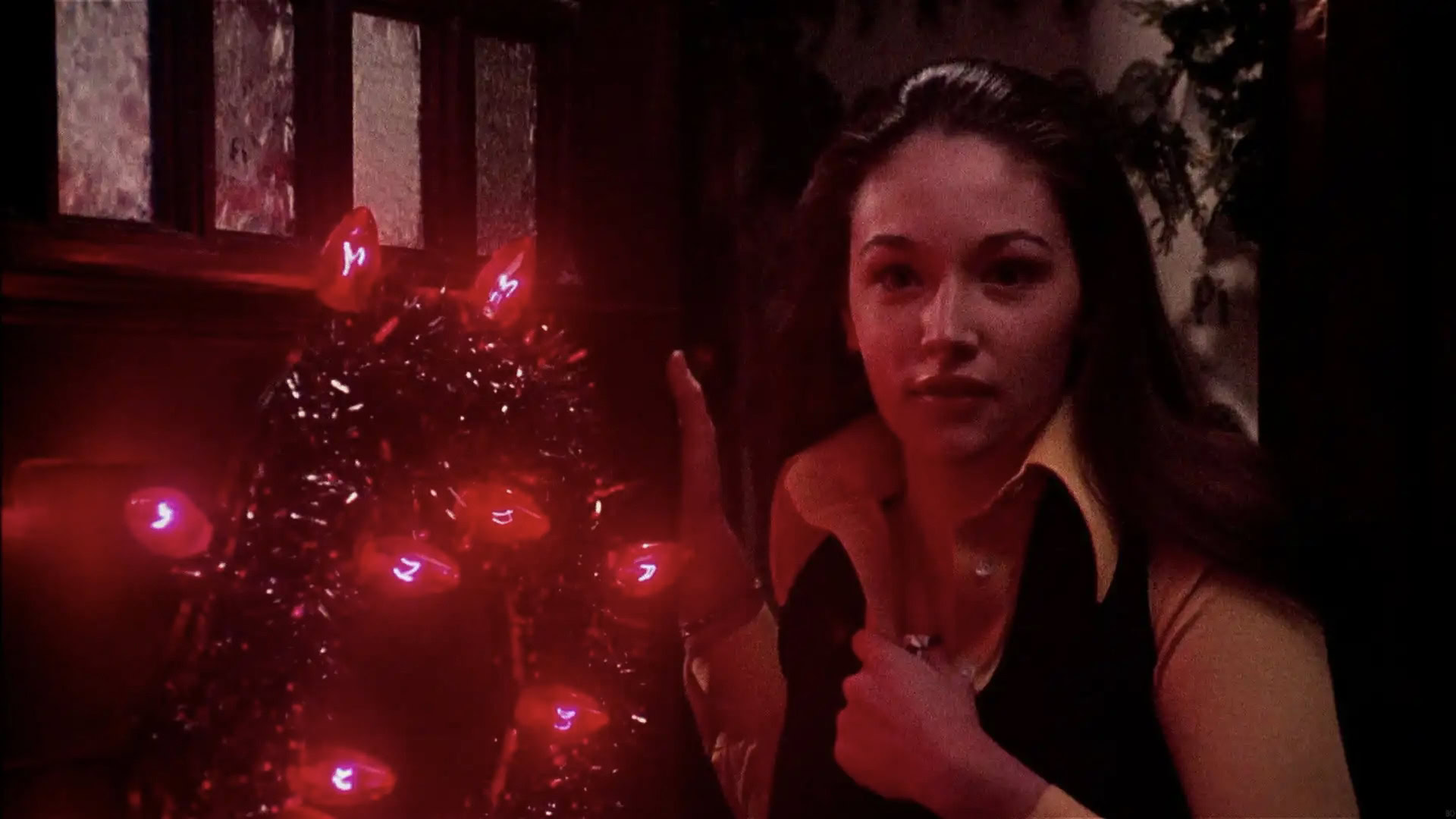 Olivia Hussey next to Christmas lights in Black Christmas