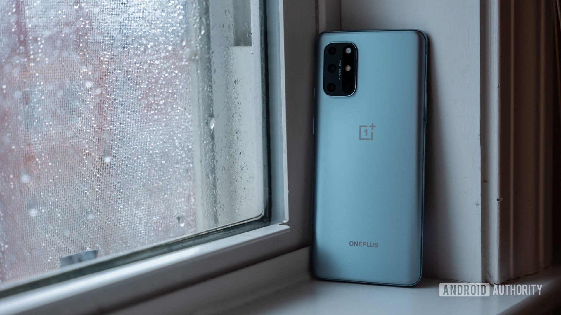 OnePlus 8T sitting on windowsil