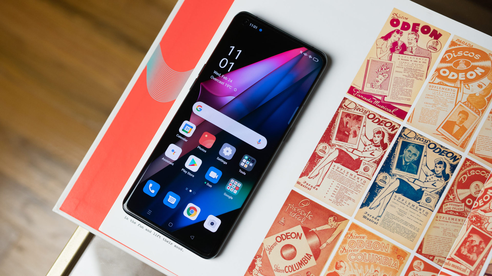 OPPO Find X3 Pro 5G flat on a colorful red and white comicstrip book.
