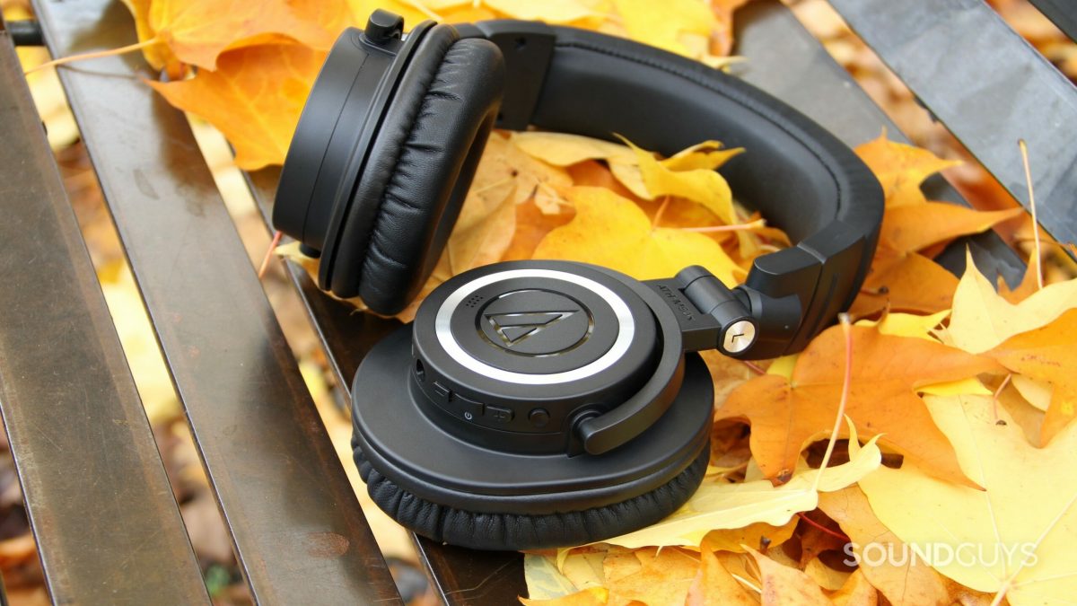 The Audio-Technica ATH-M50xBT2 Bluetooth headphones on a bed of fall leaves.