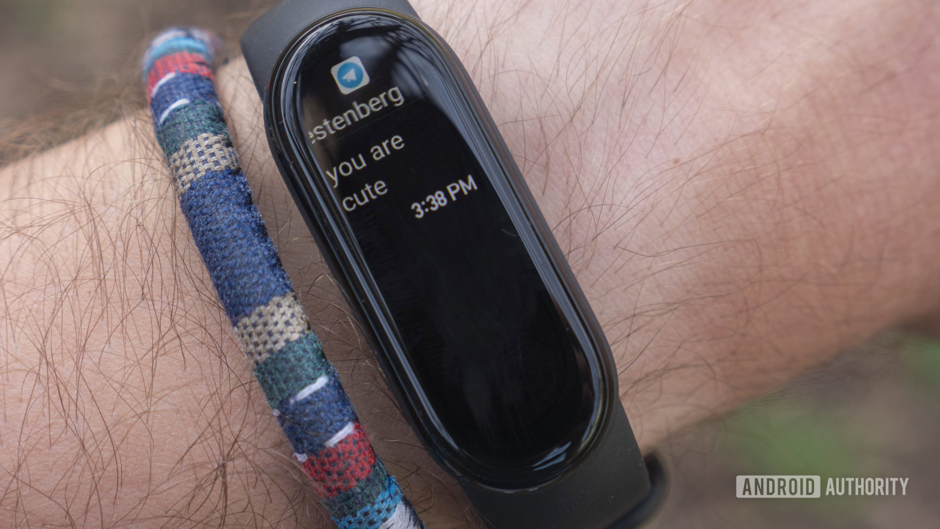 A user receives a Telegram message on his Xiaomi Mi Band 6.