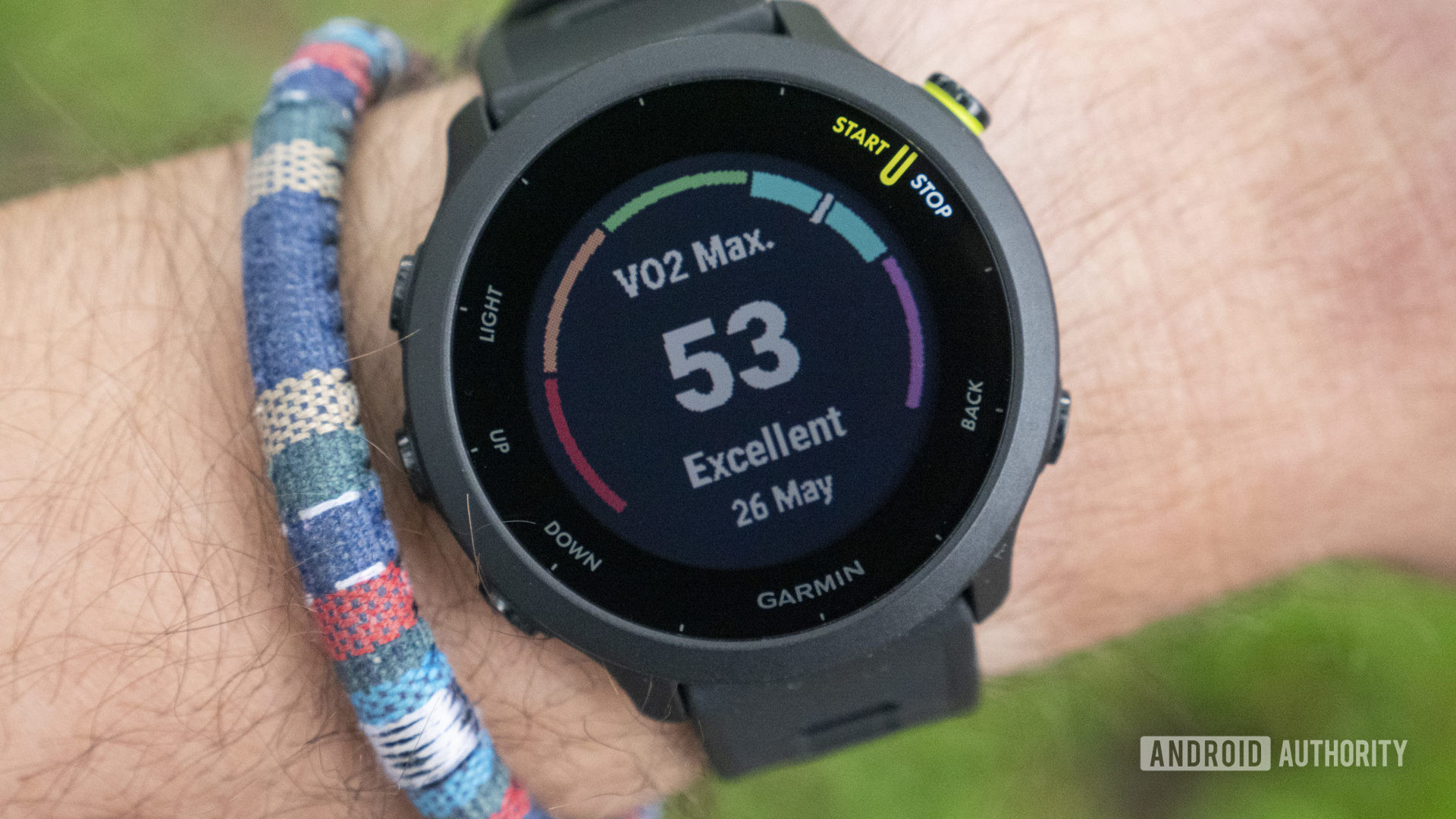 A Garmin Forerunner 55 on a user's wrist displays excellent VO2 Max data.