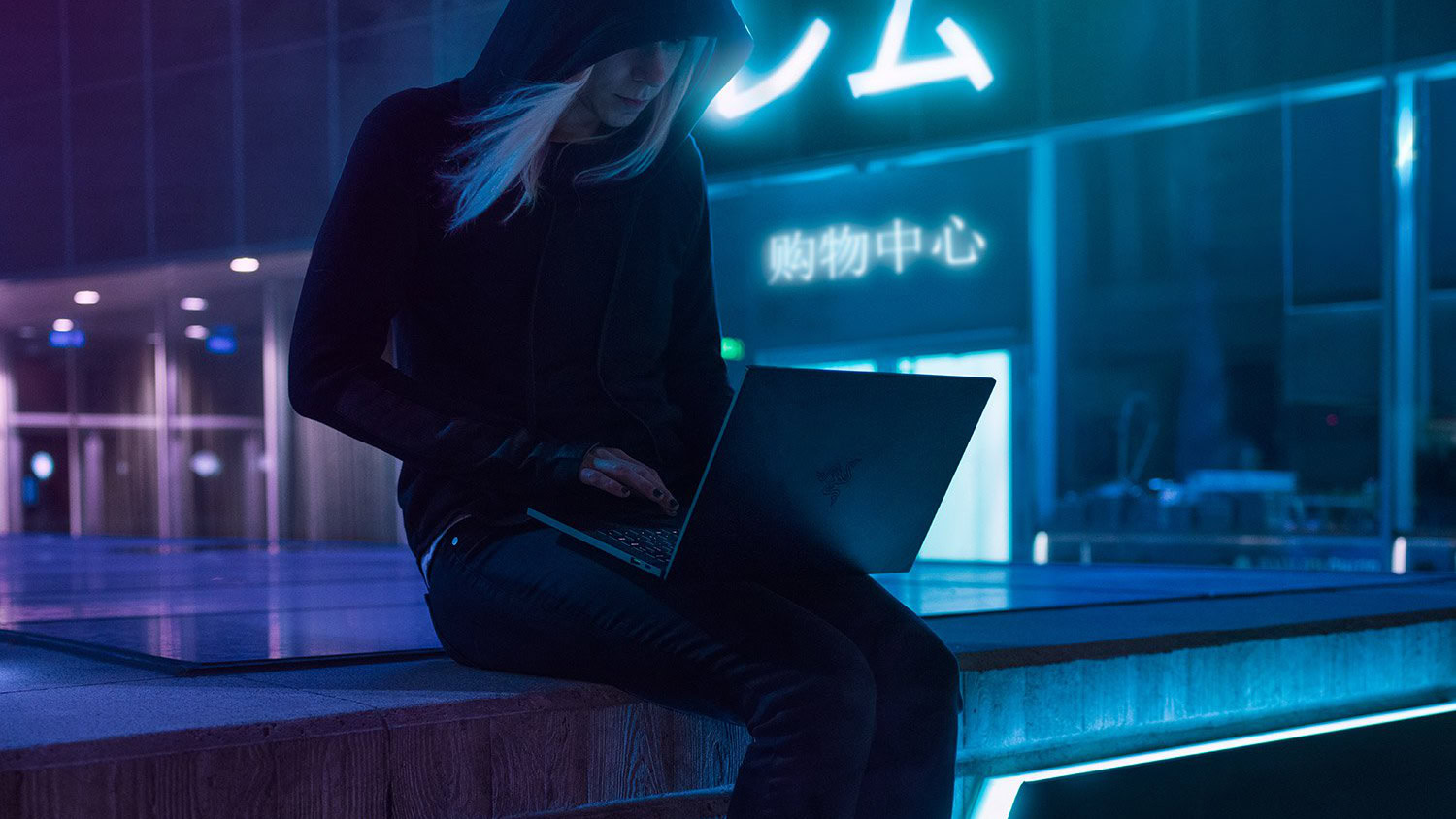 Woman using gaming computer on roof