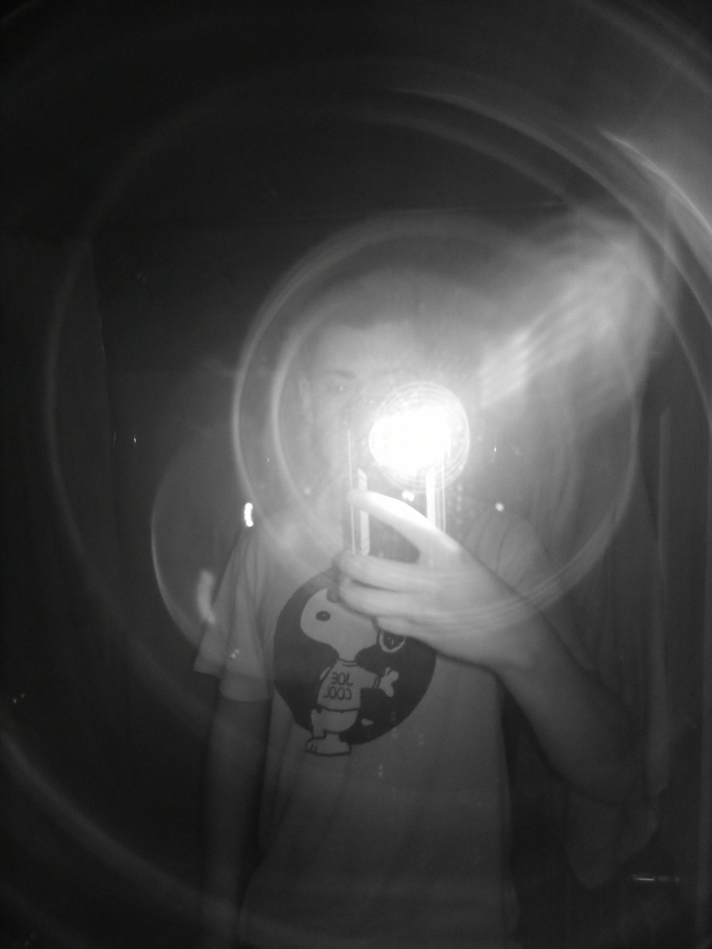 Doogee S96 Pro Night Vision Camera Sample showing a man taking a photo with his phone and a halo of the flash.
