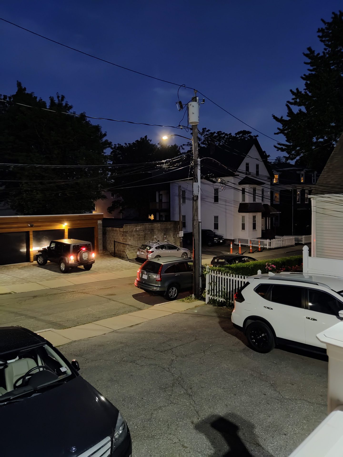 TCL 20 Pro 5G Camera nighttime shot of a street and cars parked, some with their lights on.
