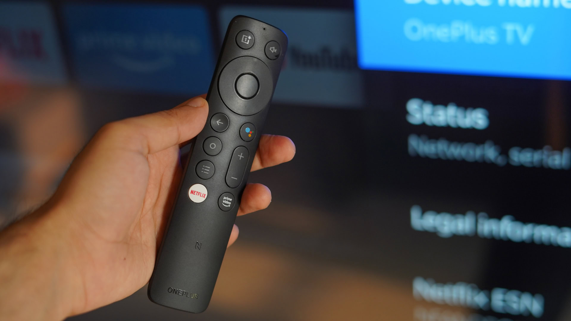 A hand holding the OnePlus TV U1S remote.
