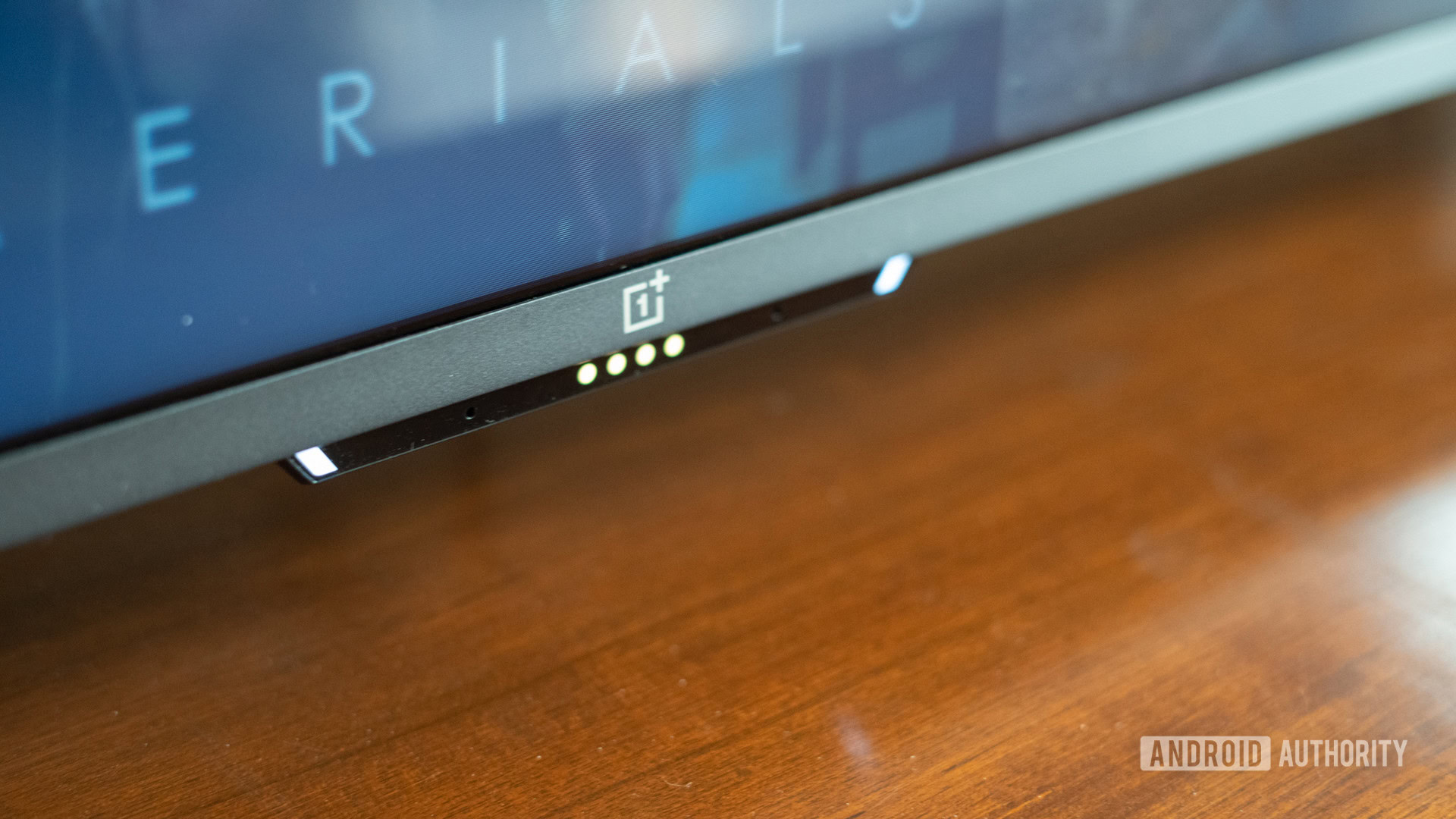 The OnePlus TV U1S showing the front module with lights and logo.