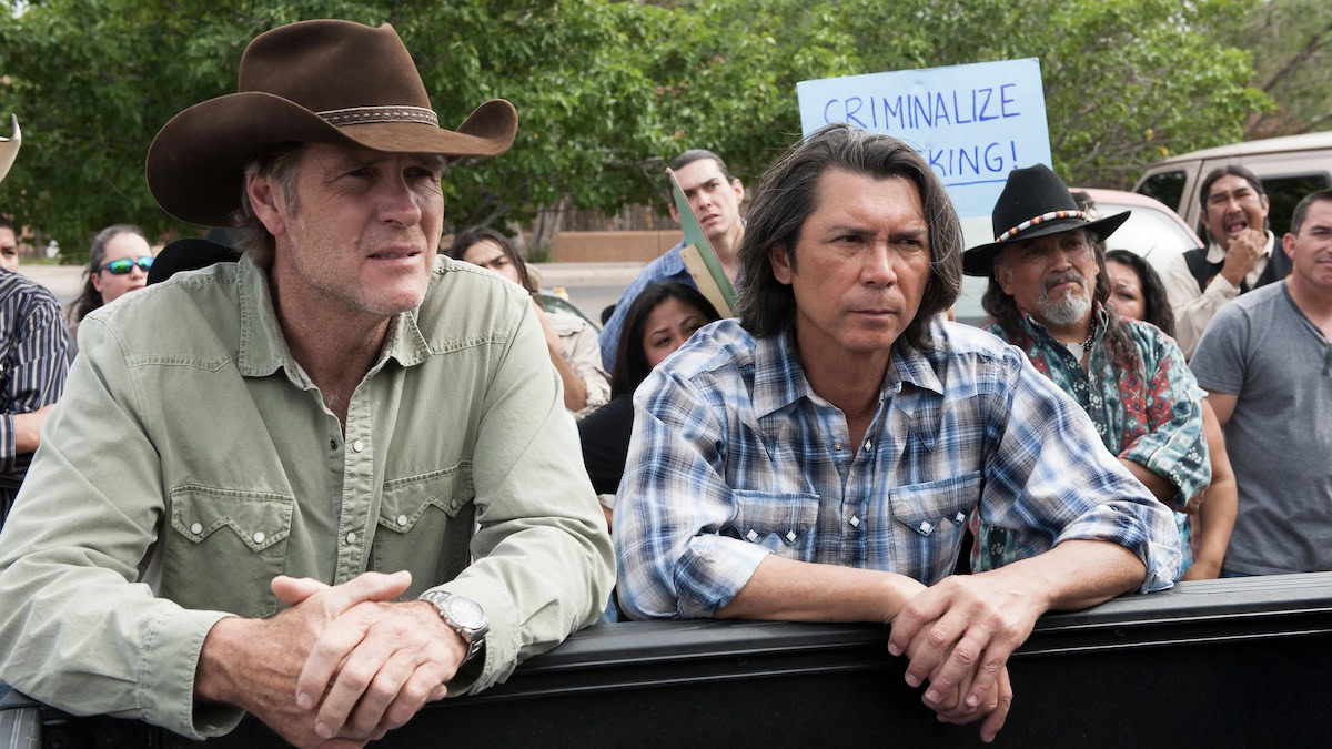 Robert Taylor and Lou Diamond Phillips stand together at a protest in Longmire - best westerns on netflix