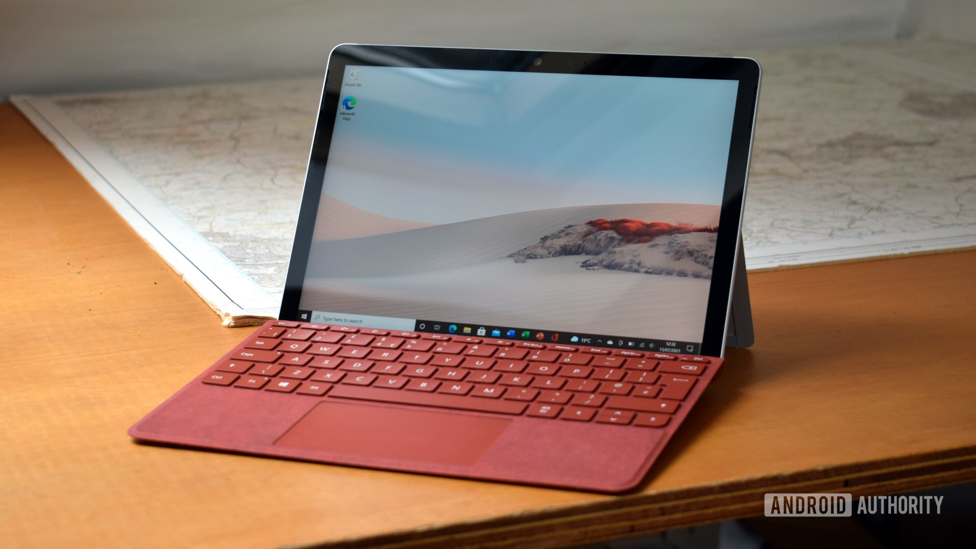 The Microsoft Surface Go 2 review with a Poppy Red Surface Go Type Cover sitting on a desk.