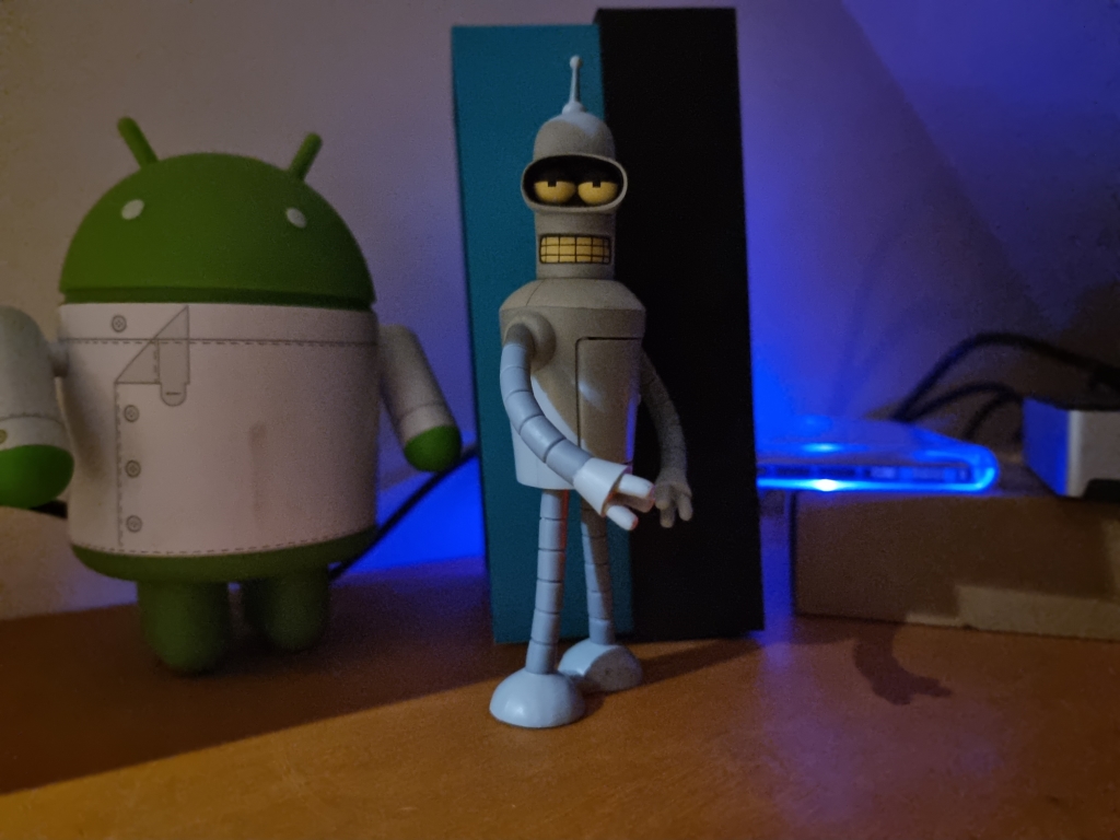 Android and Bender figurines in the dark taken on Samsung Galaxy S21 Ultra