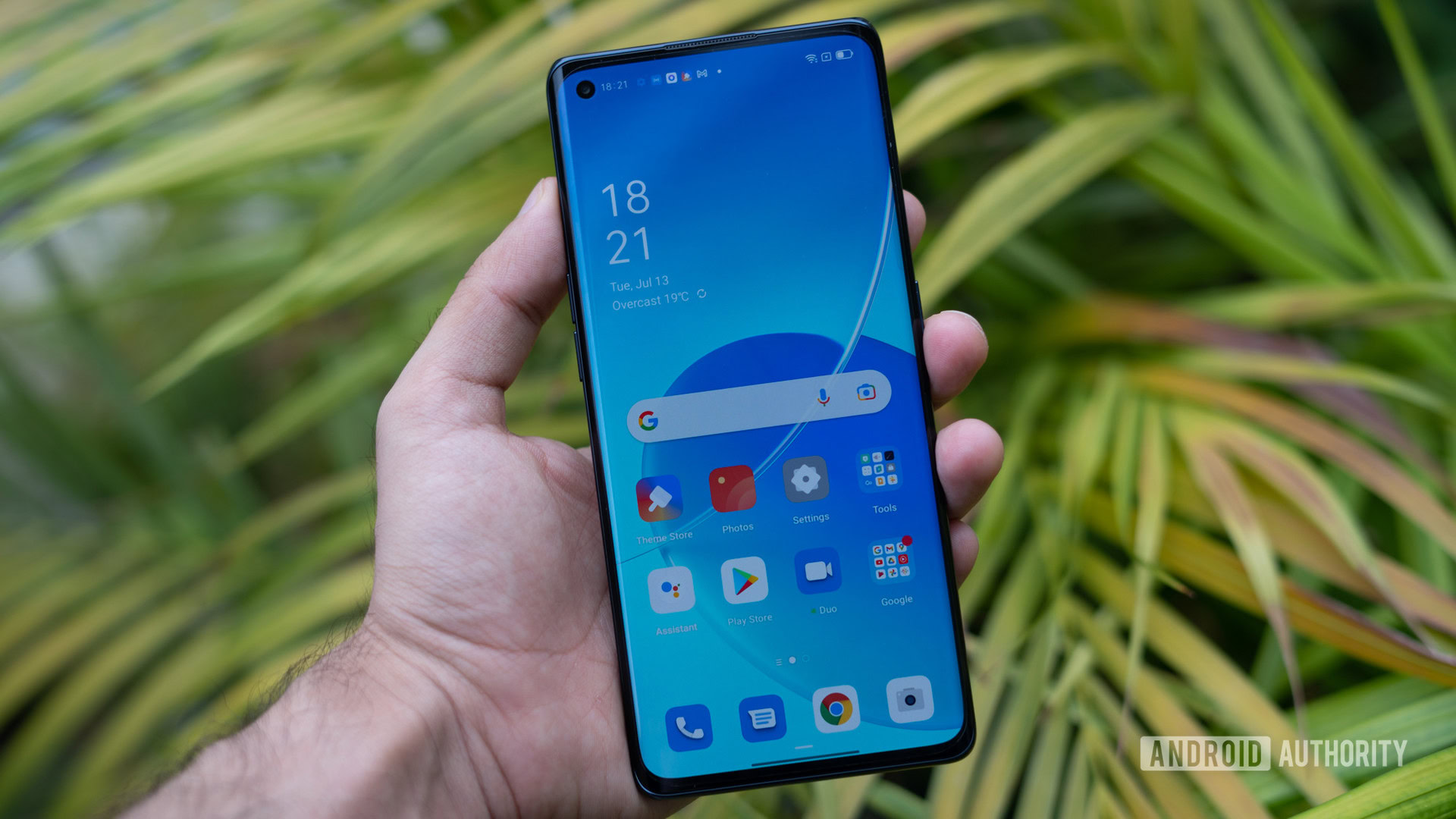 The OPPO Reno 6 Pro phone in hand showing the screen.