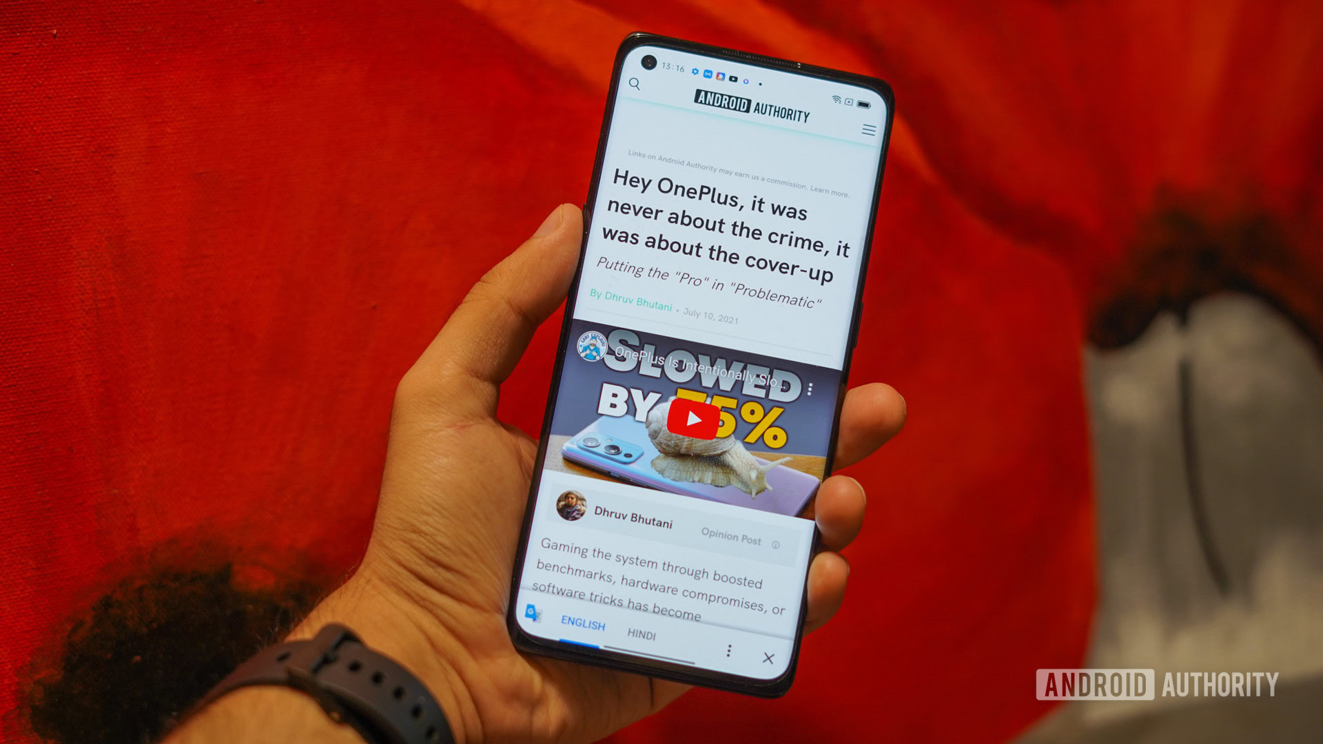 The OPPO Reno 6 Pro review in hand showing the screen with web page open.