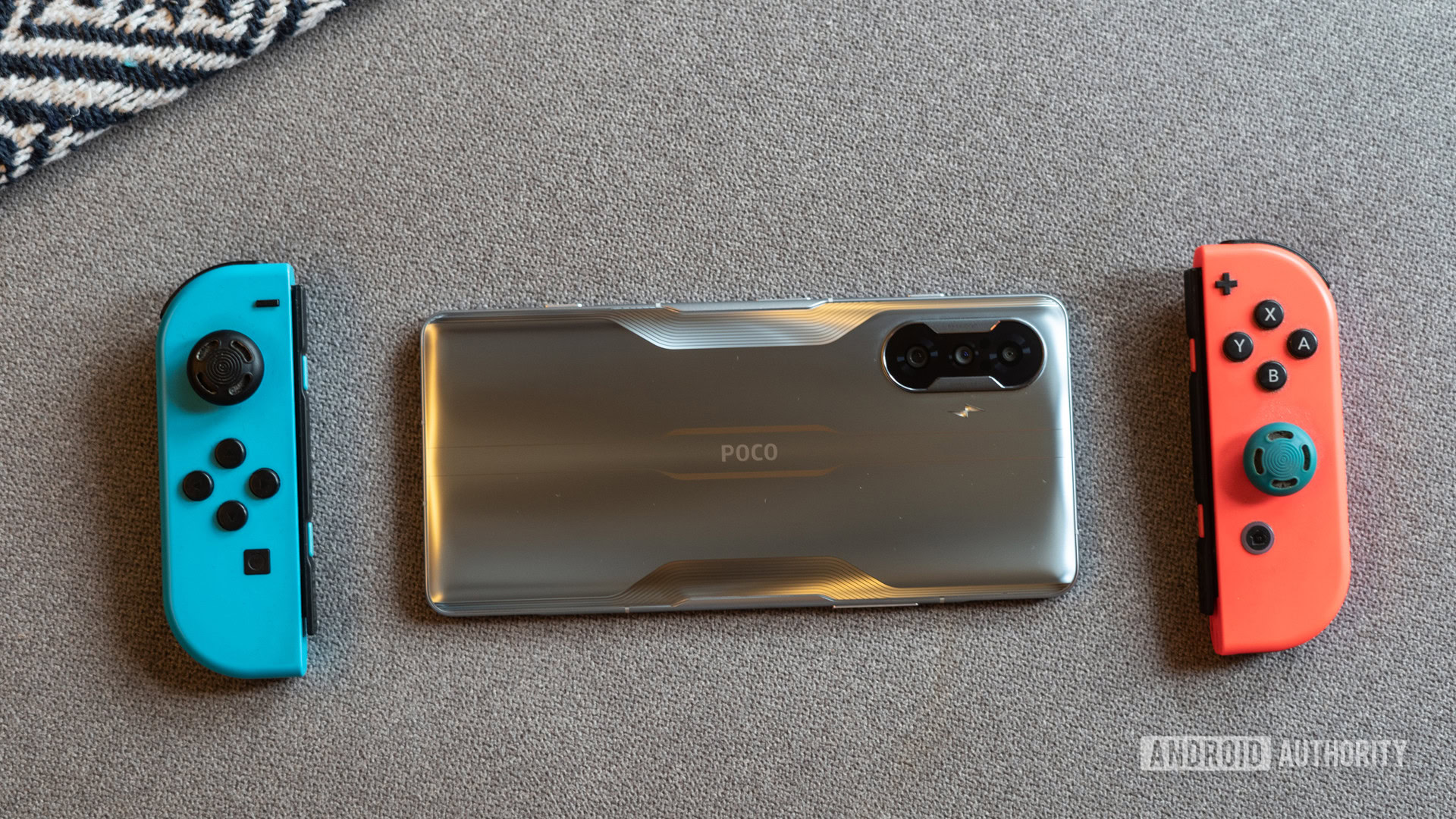 POCO F3 GT rear view with Nintendo Switch joycons