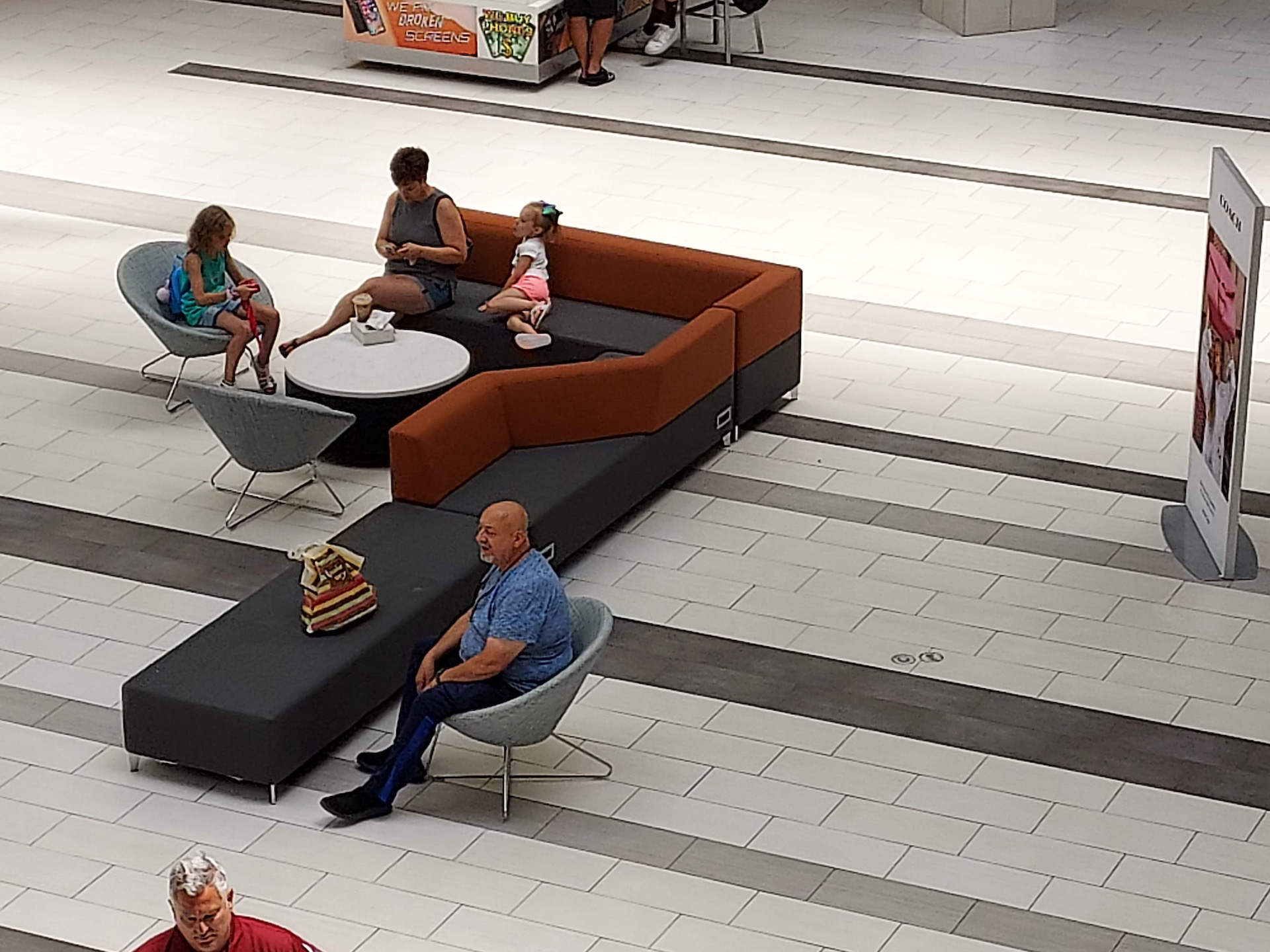Samsung Galaxy A42 photo sample 4x showing the interior view of a mall with people sitting down around a table