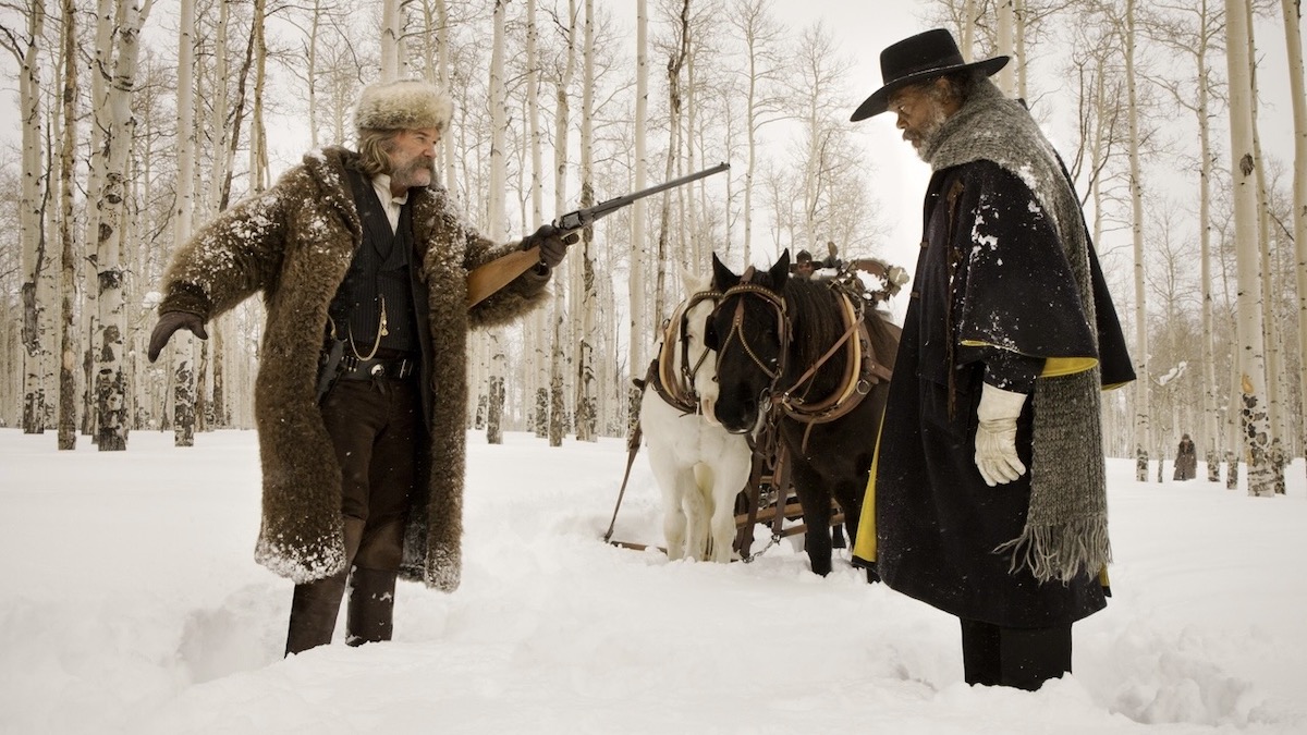 Kurt Russell aims a rifle at Samuel L. Jackson in the snow in The Hateful Eight - best westerns on netflix