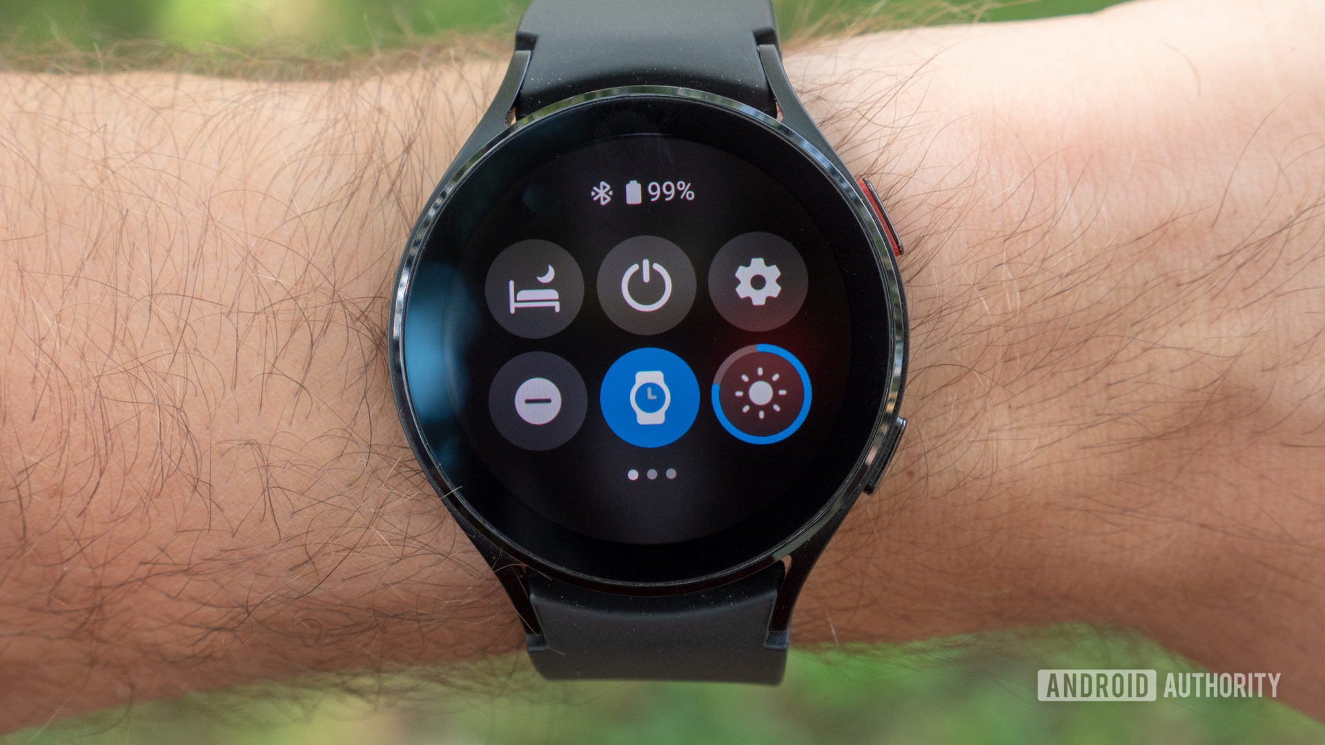 A user opens the quick settings menu on their Wear OS device.