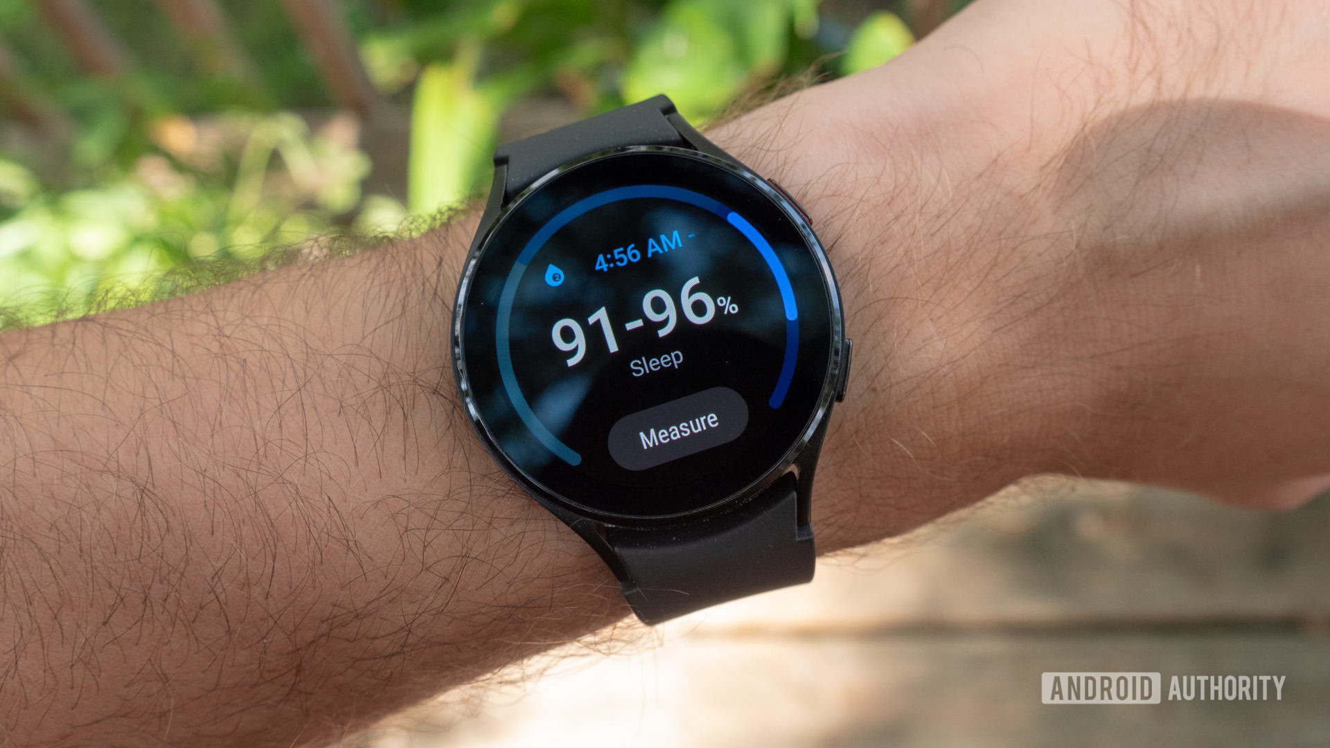 The Samsung Galaxy Watch 4 on a man's wrist showing the nighttime SpO2 monitoring screen.