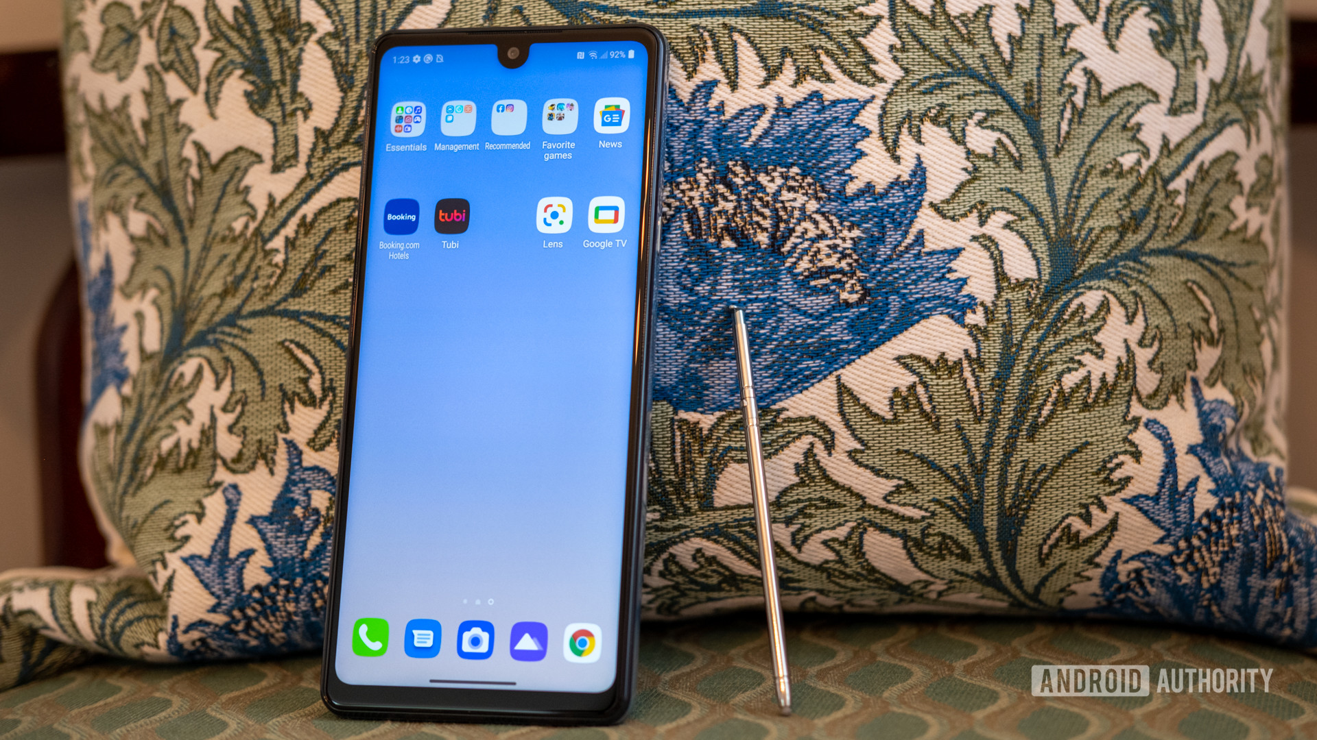 LG Stylo 6 open to extra apps on a patterned chair