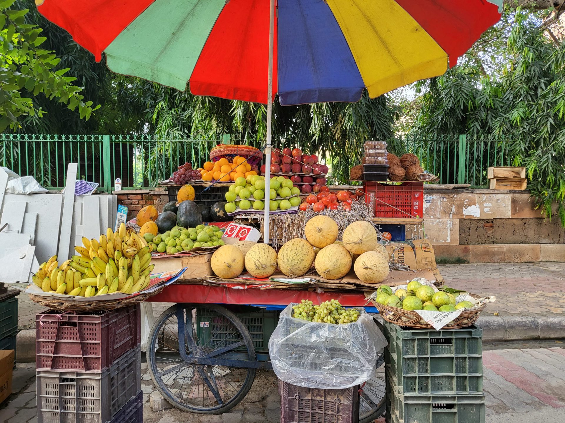 Samsung Galaxy Z Flip 3 primary camera fruit seller stand with fruit and a colorful umbrella