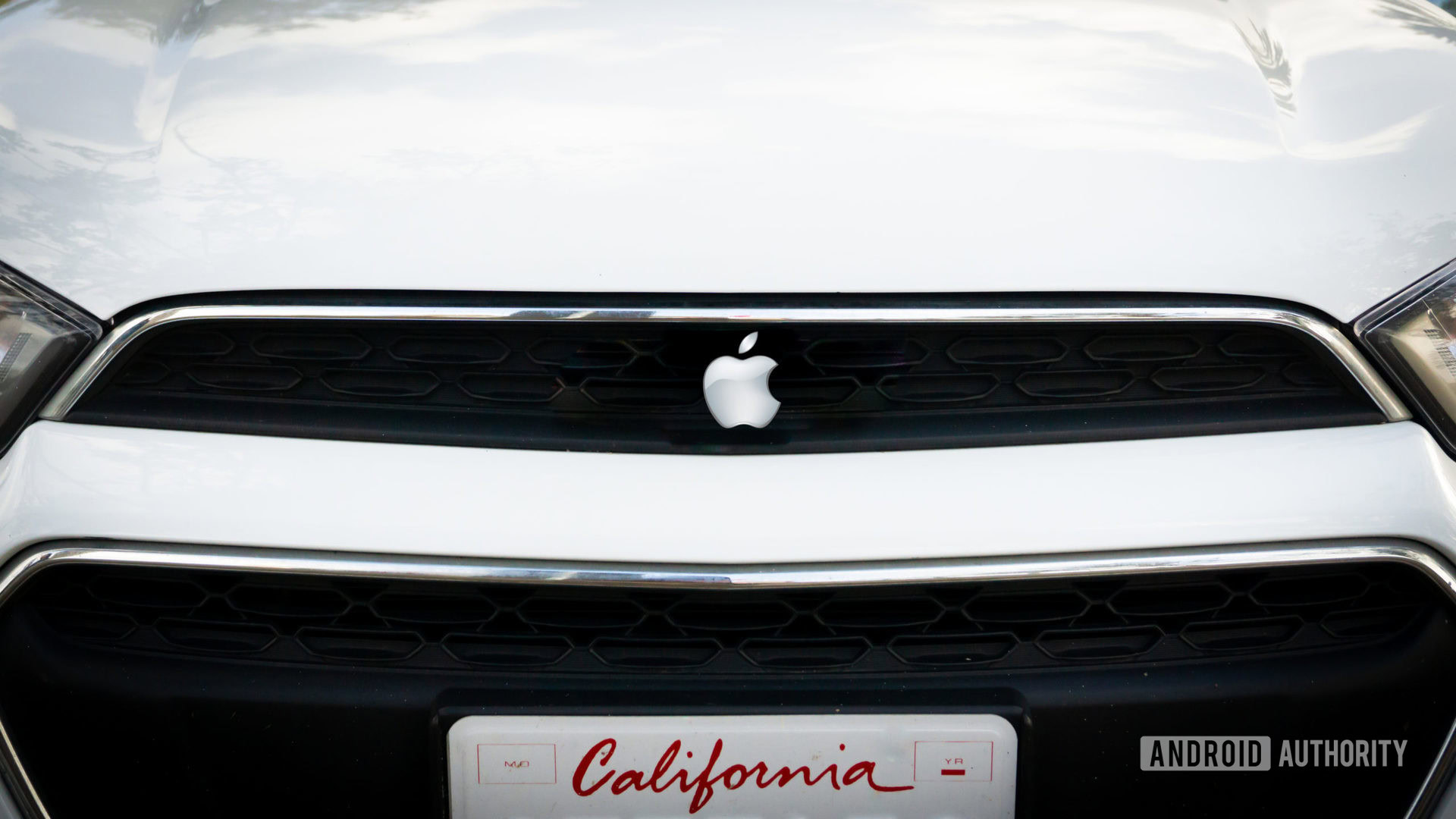 Apple Car Mockup showing front closeup of vehicle with the Apple logo.