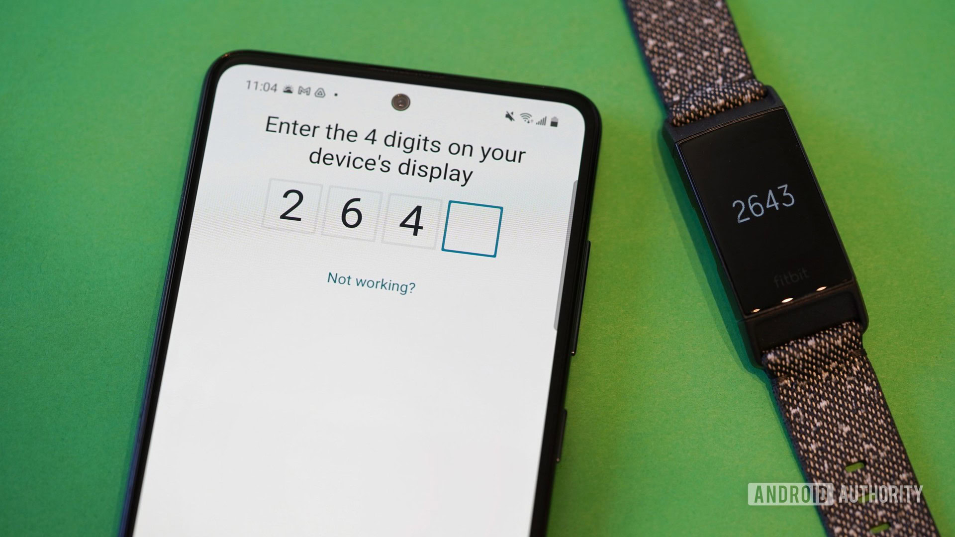A Fitbit Charge 4 displays its 4 digit pairing code while a Galaxy A51 pairs to the device.