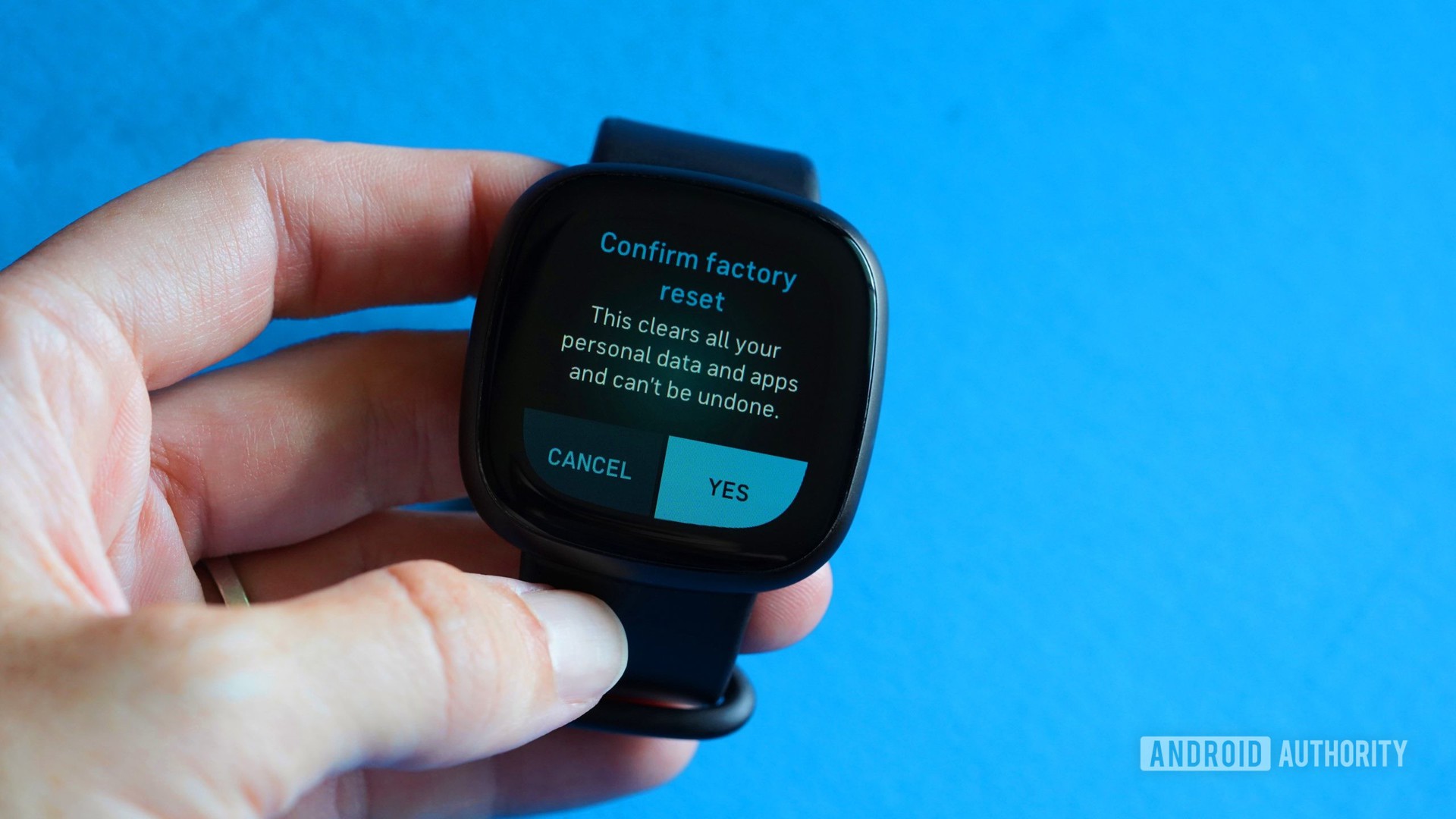 A Fitbit Versa 3 users navigates to the Factory Reset confirmation screen. 