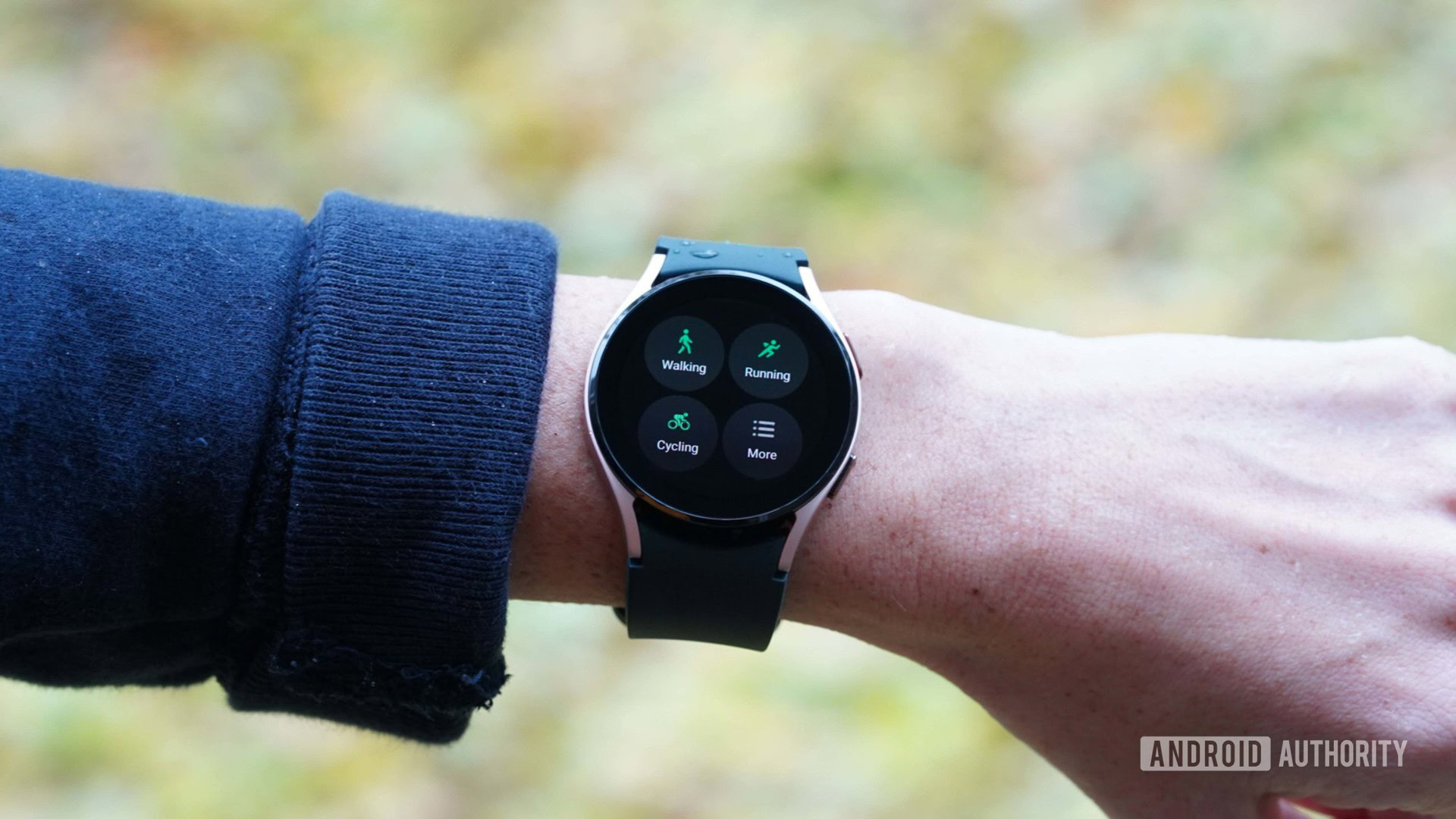 A Samsung Galaxy Watch 4 on a woman's wrist displays workout options in the Samsung Health app.