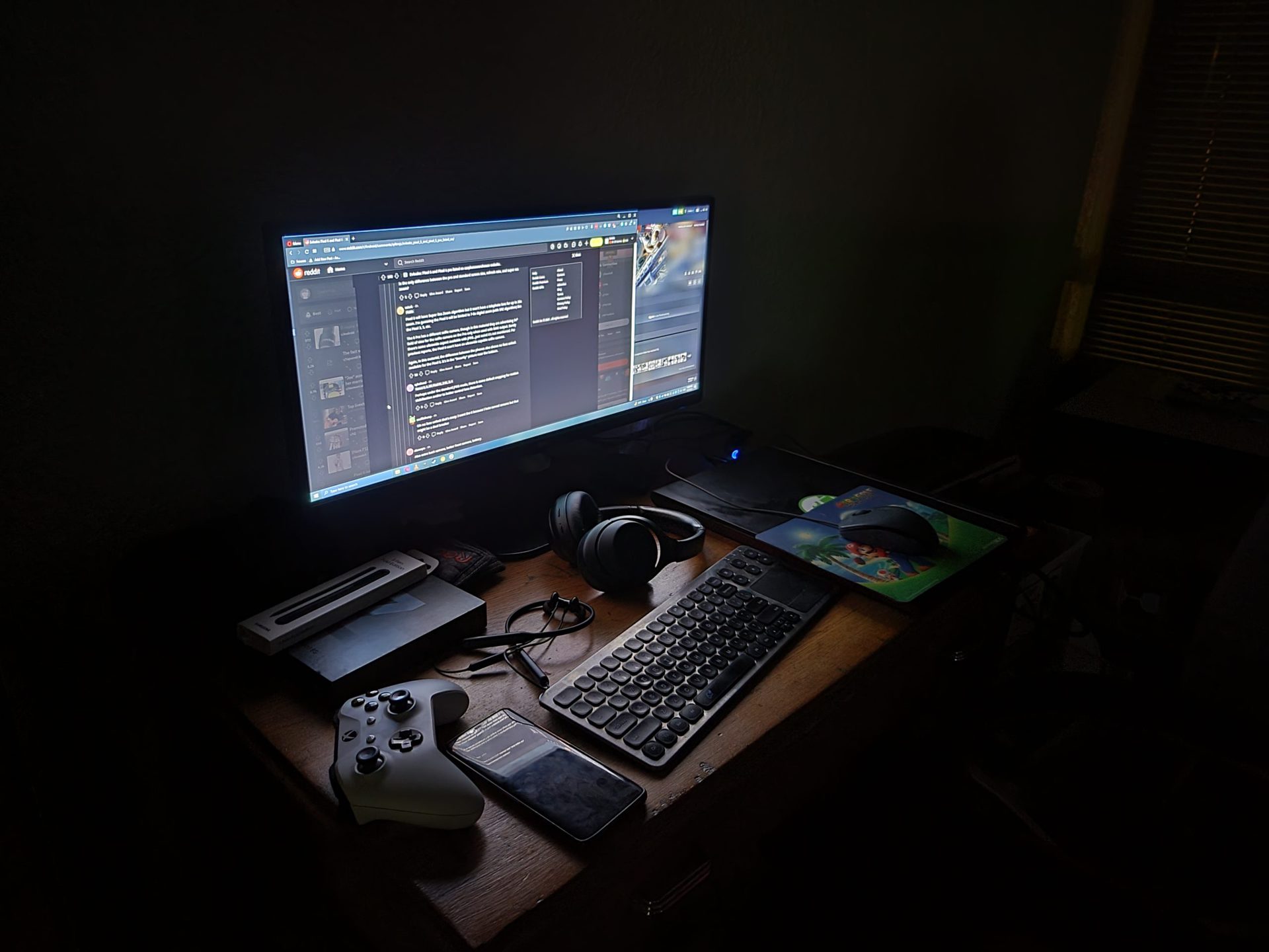 Galaxy Z Fold 3 desk low light night mode shot showing a keyboard, monitor, and accessories.