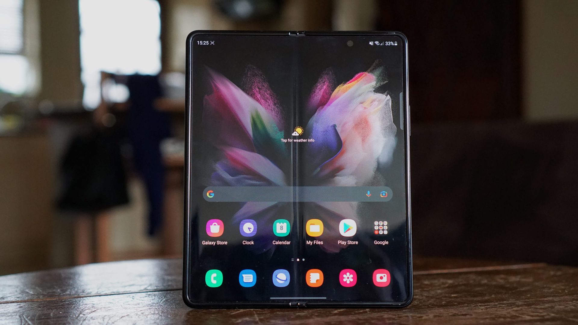 Galaxy Z Fold 3 unfolded standing upright on a table