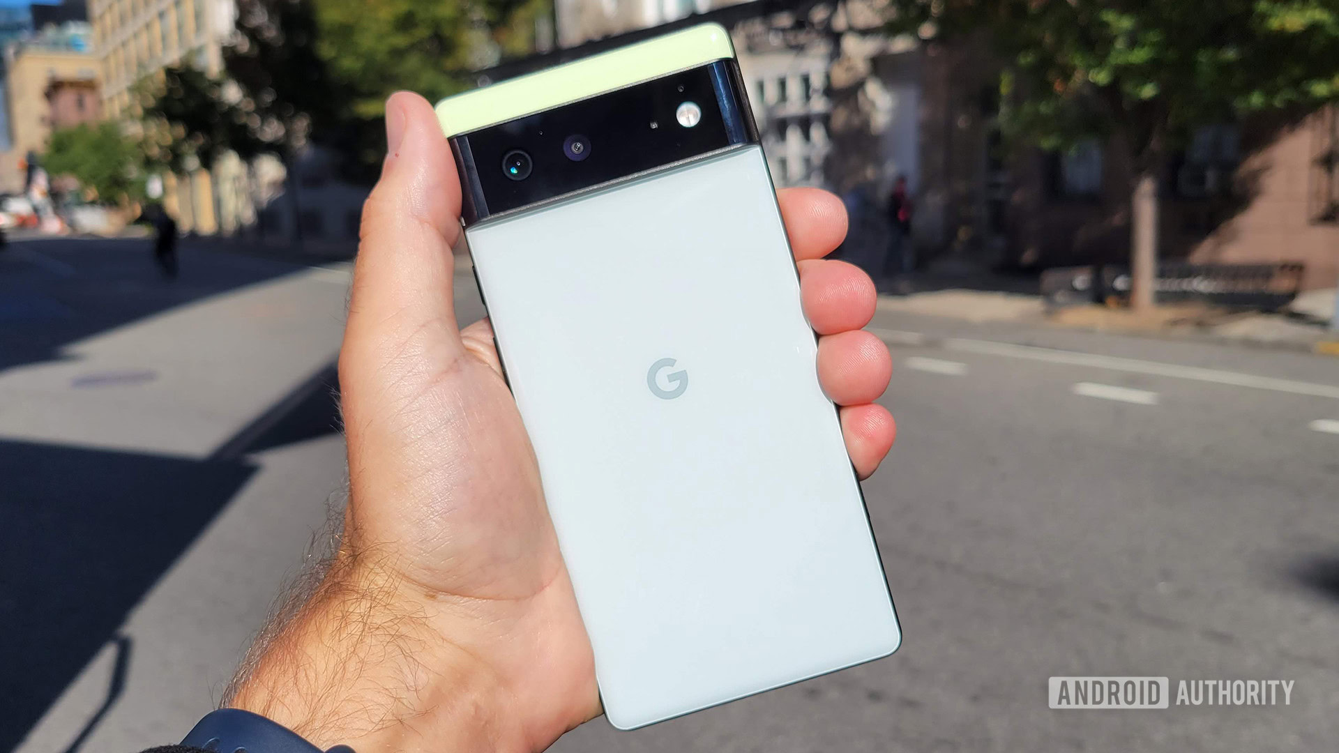 Google Pixel 6 in hand on city street