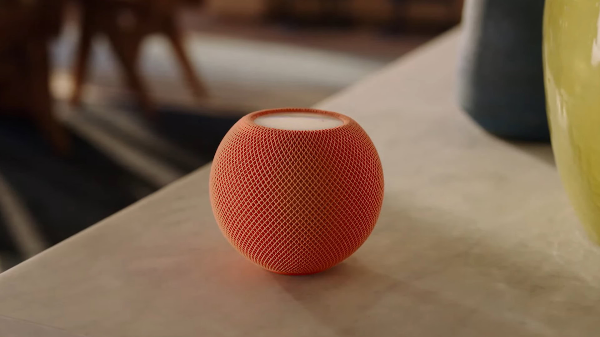 An Apple HomePod mini in orange