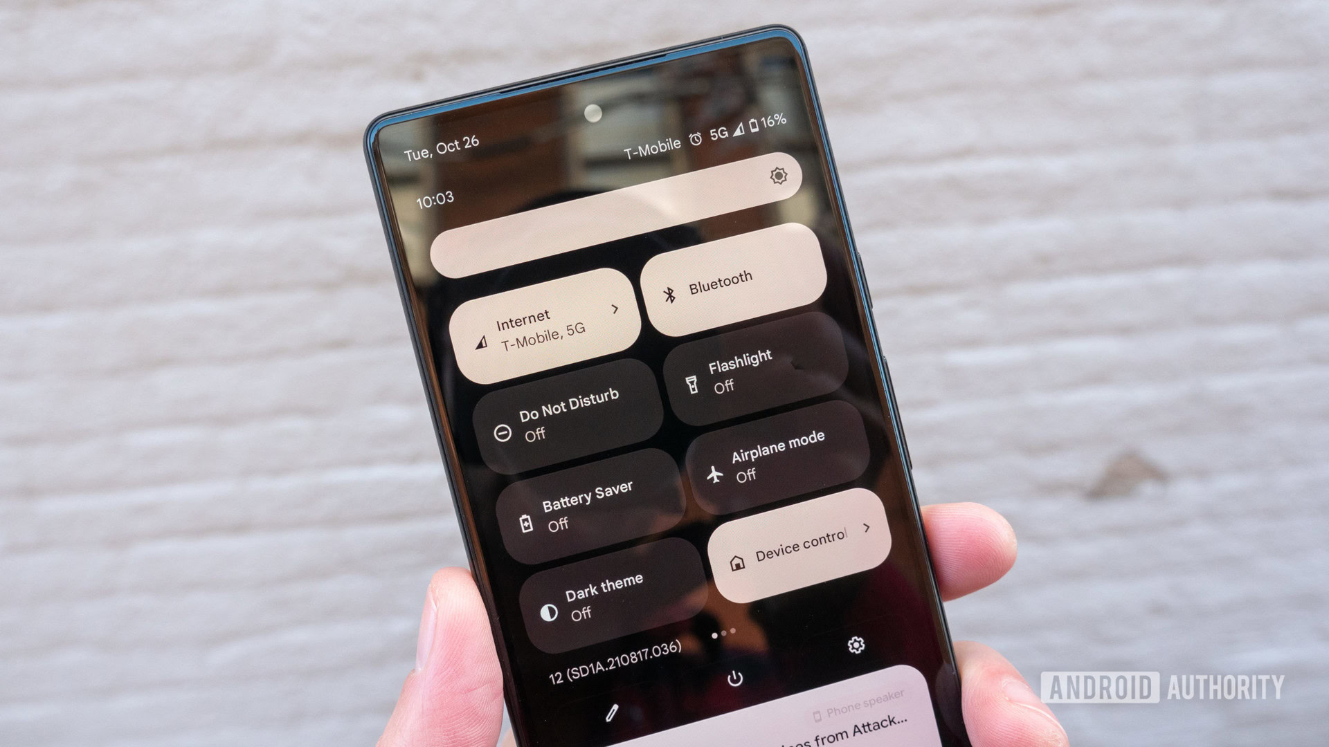 The Google Pixel 6 in hand showing the quick settings panel