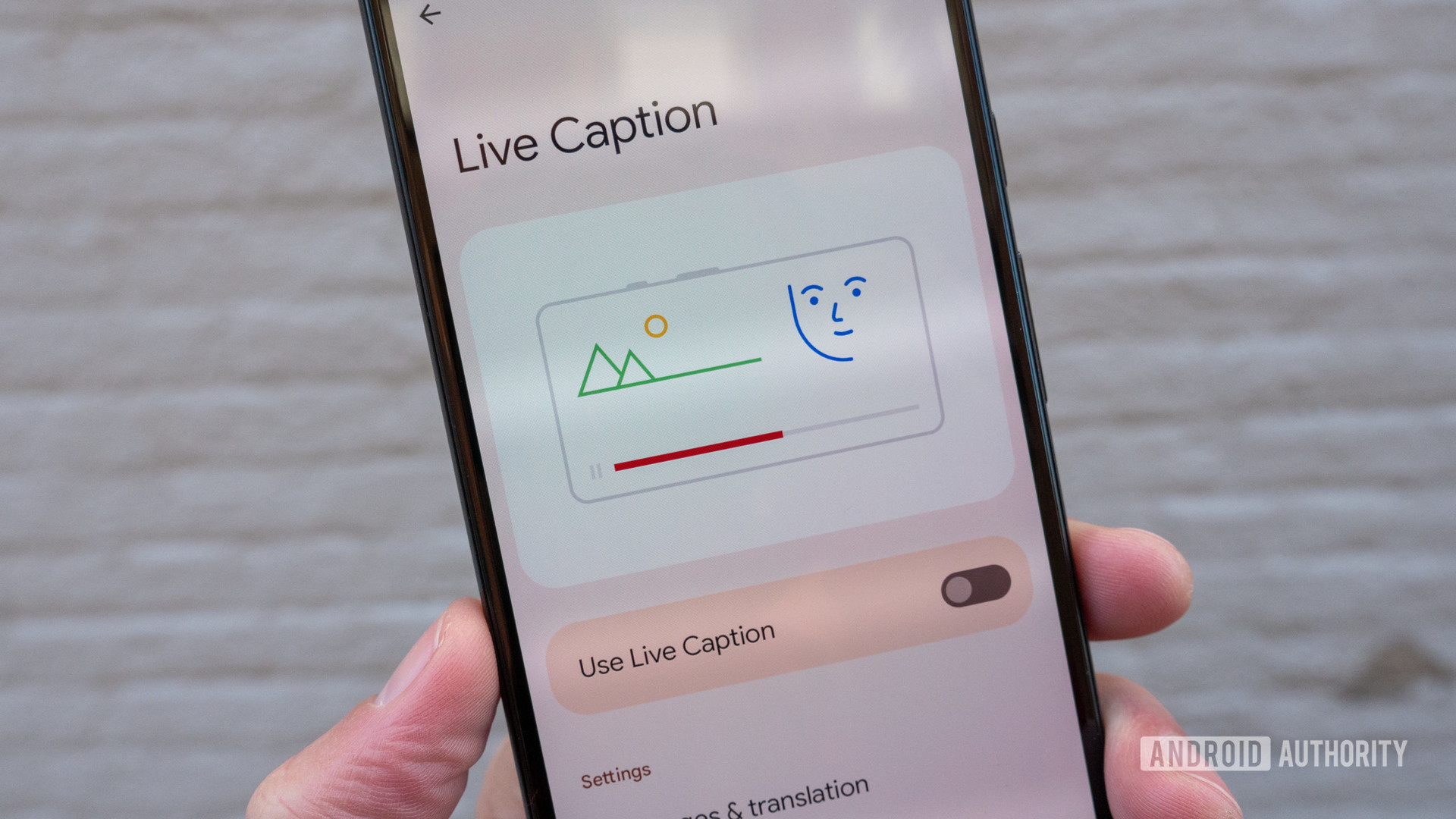 The Google Pixel 6 in hand showing the Live Caption settings page