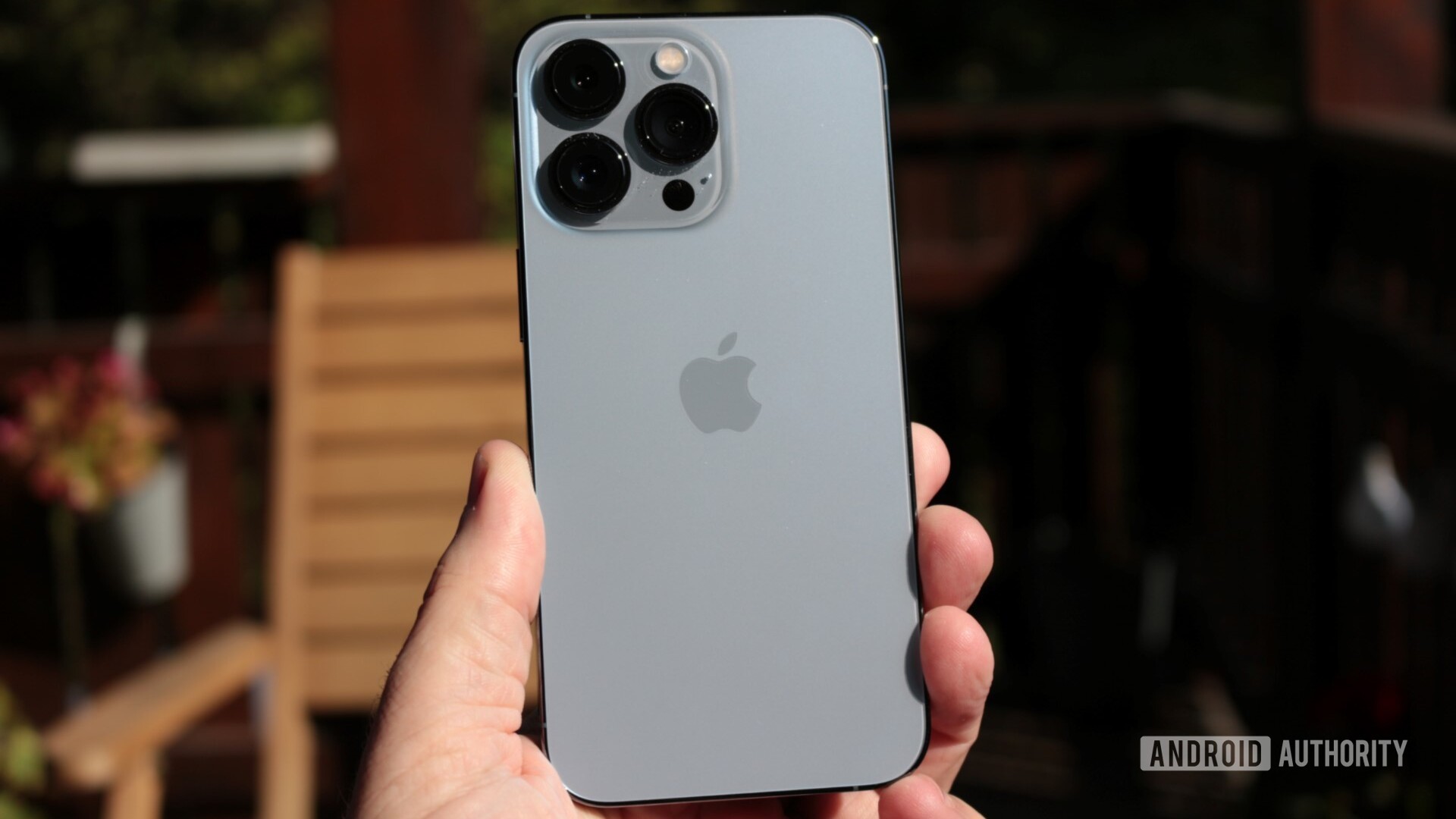 iPhone 13 Pro back in hand outdoors