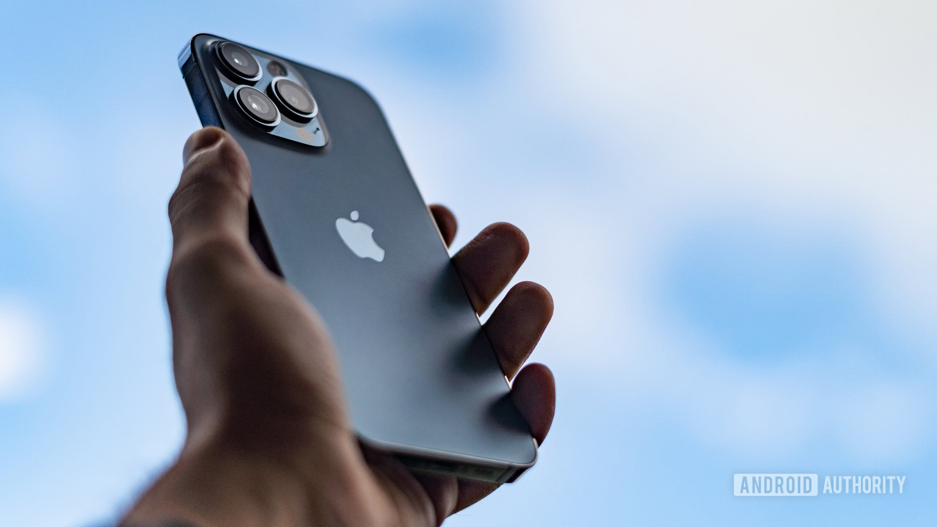 iPhone 13 Pro review in hand facing the sky