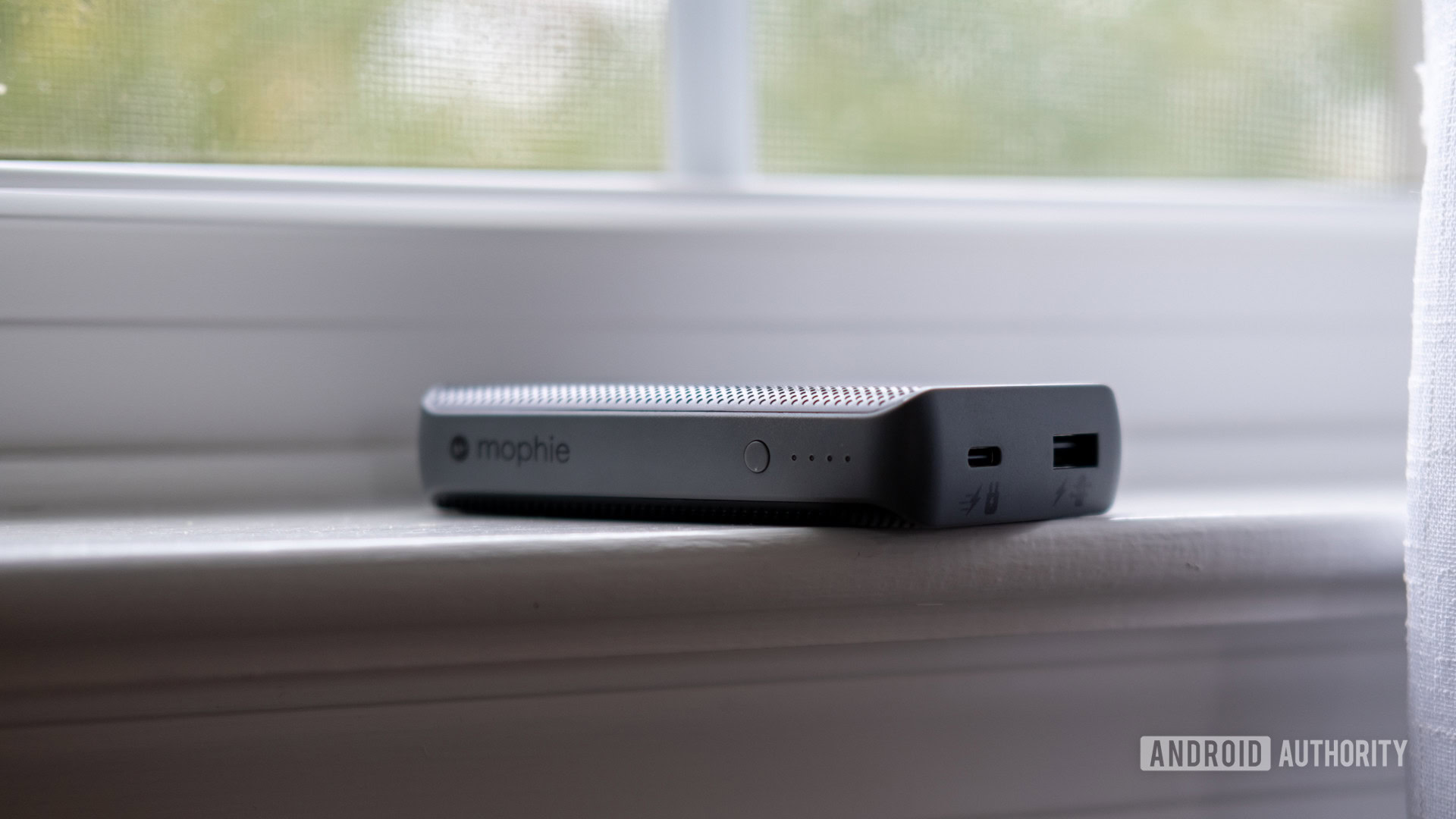 The Mophie PowerStation PD XL on a window sill showing buttons and ports.