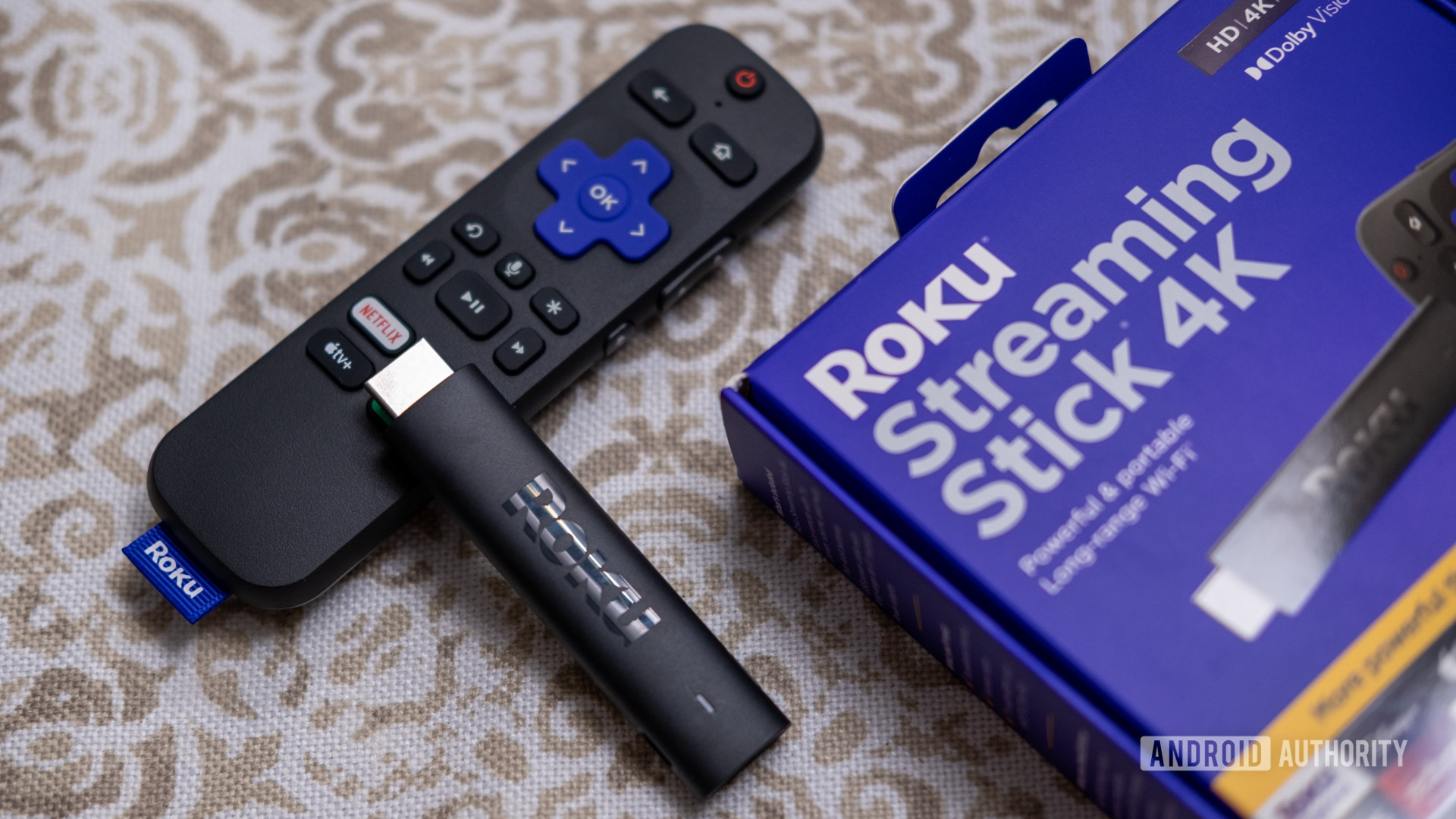 Rroku streaming 4K stick next to its box.