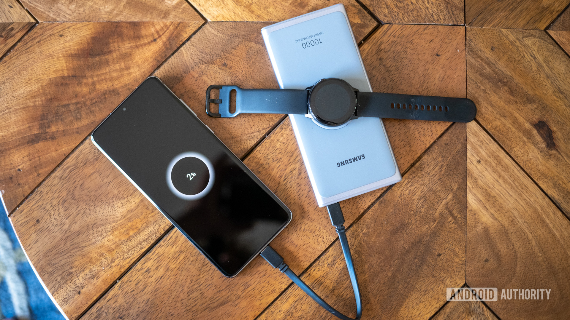 samsung super fast power bank on table with watch